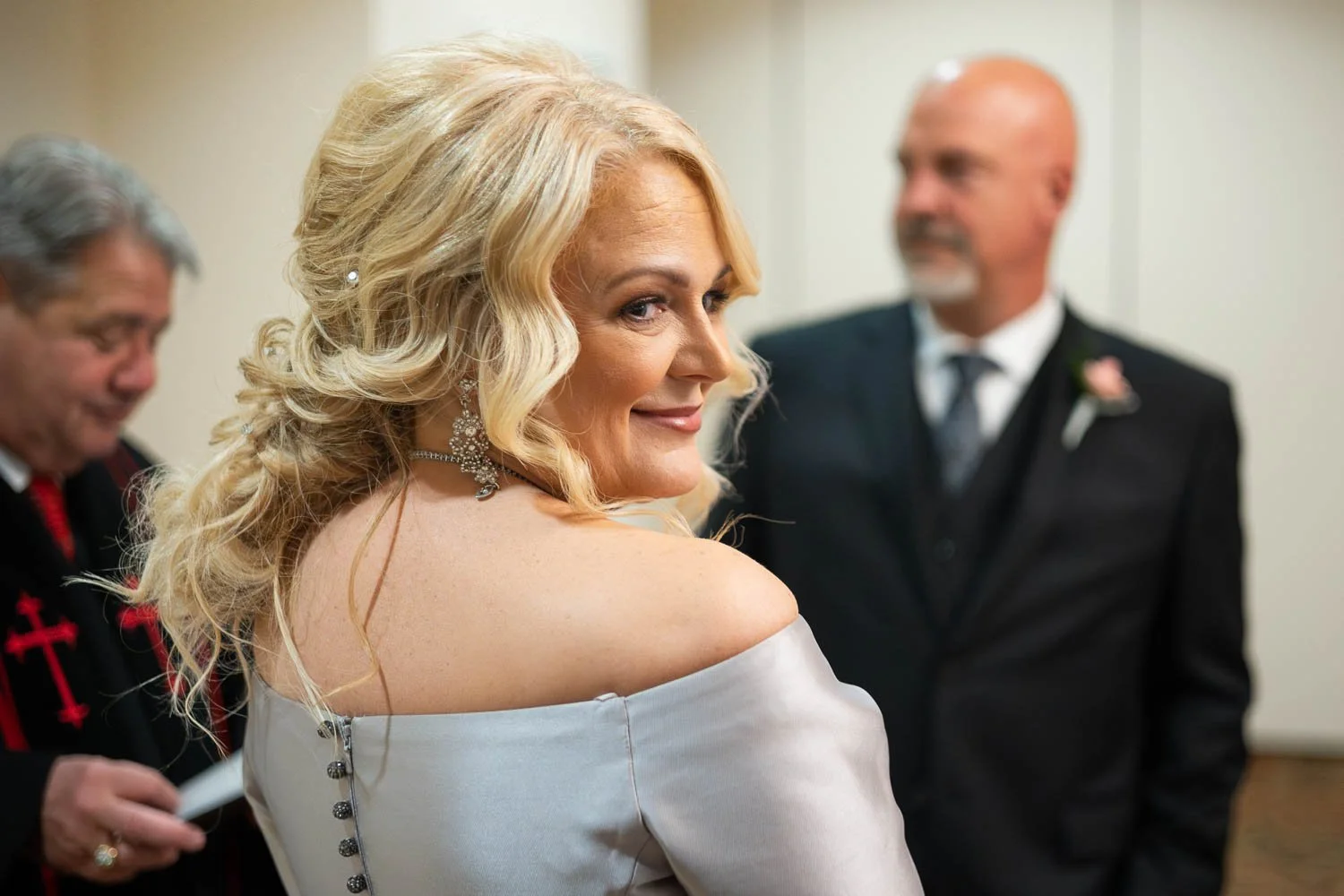 bride smiling at her children during the wedding vows, josh and lindsey photo