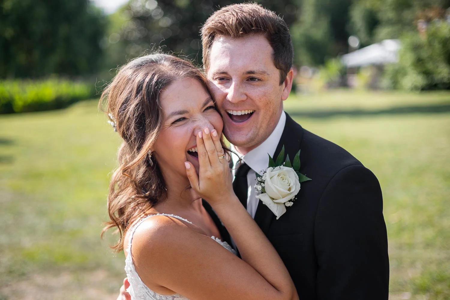 bride and groom laughing with each other in the sunny St Louis Tower Grove Park