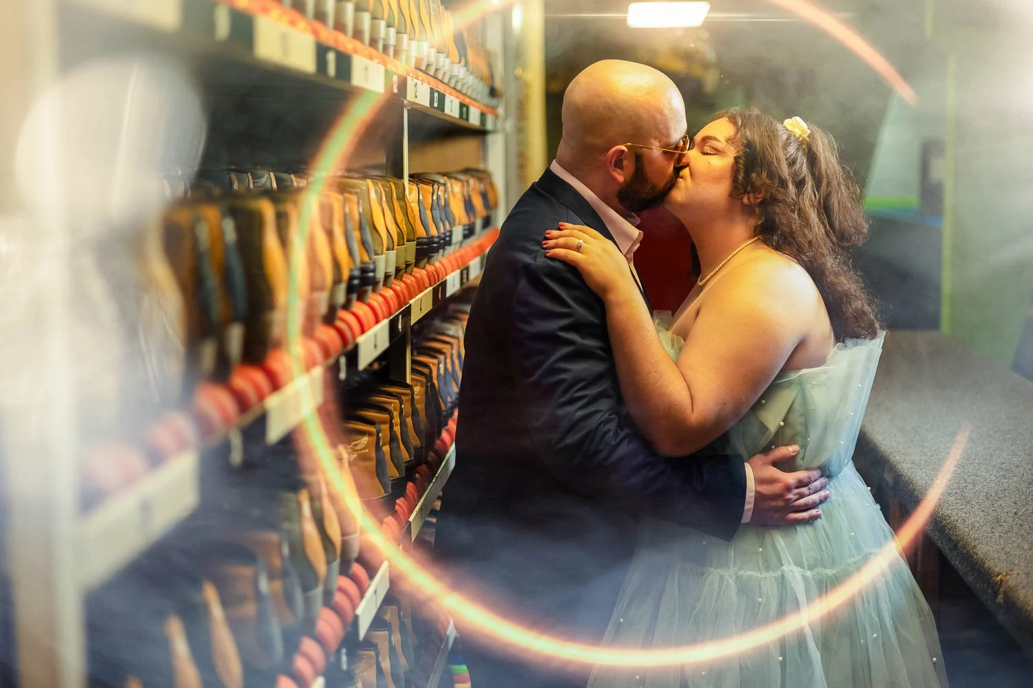 couple kissing behind the counter at a roller skating rink-josh and lindsey photo