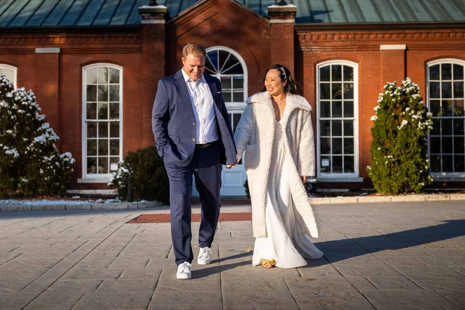 husband and wife walk hand in hand - st louis wedding documentary wedding photographers