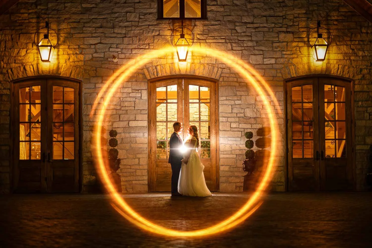Bride and groom pose for a wedding portrait at night, Stone House of St Charles