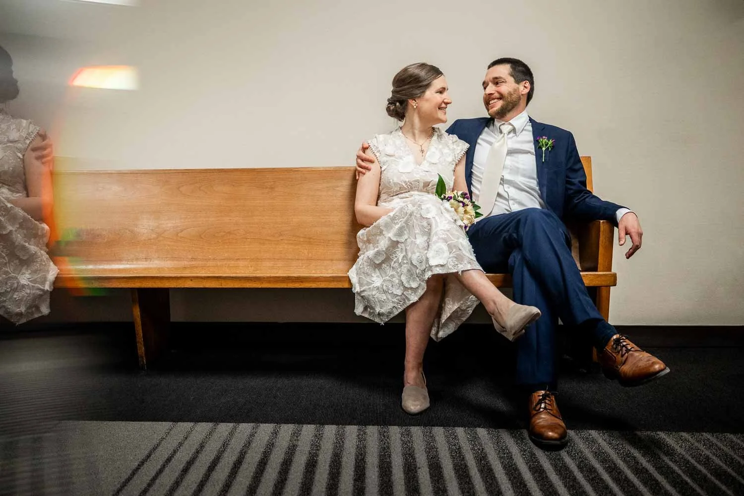 newly married couple sit on courthouse bench holding each other - st louis missouri elopement photographer