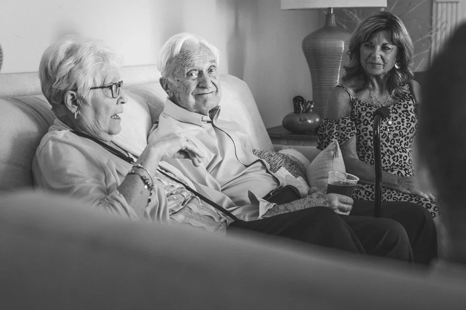 black and white photo of wedding guest sitting on couch-josh and lindsey photo
