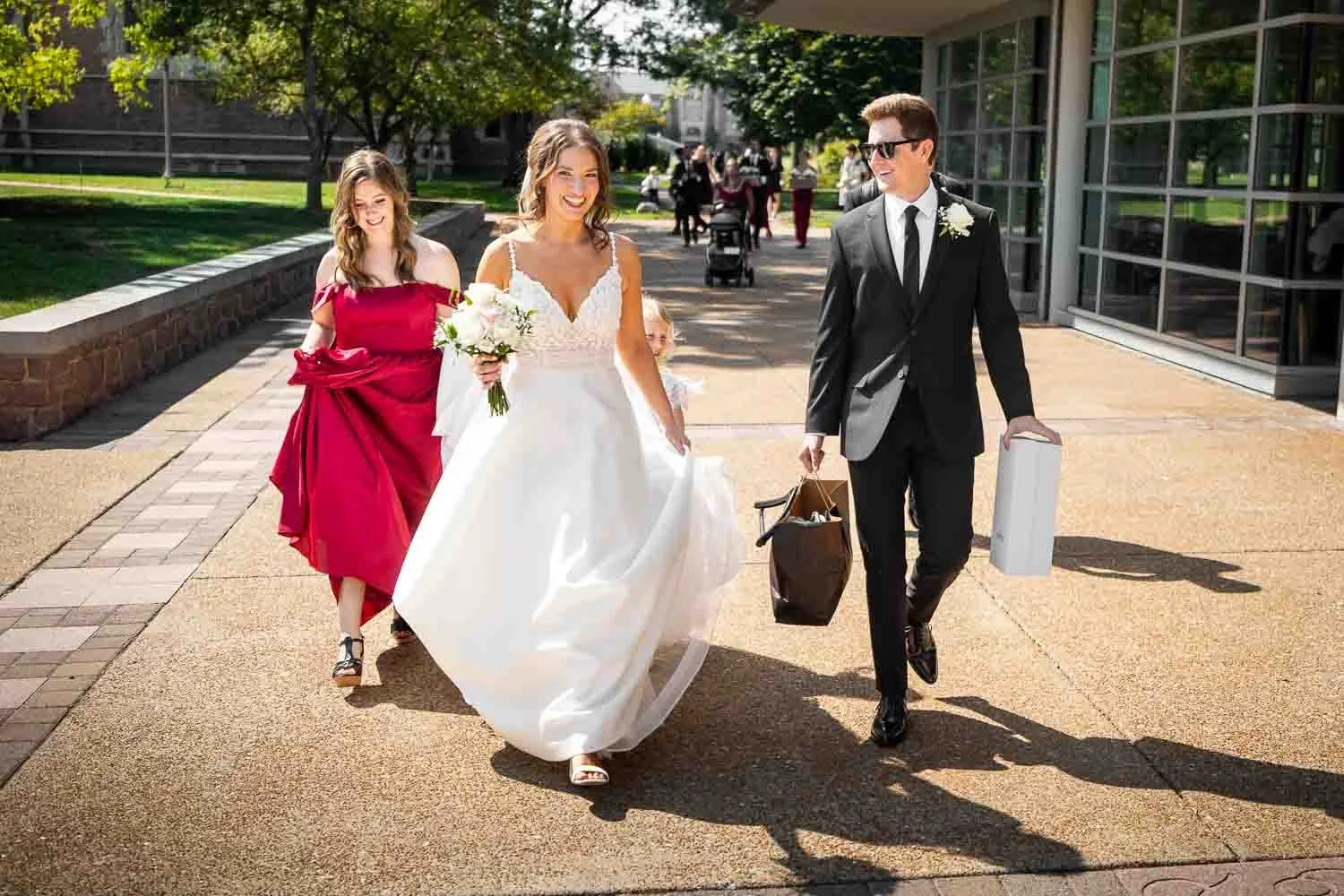 couple smiling and walking through Washington University-st louis wedding photography