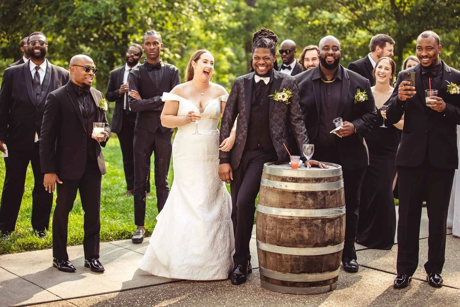 bride and groom laugh during wedding speeches with their wedding party