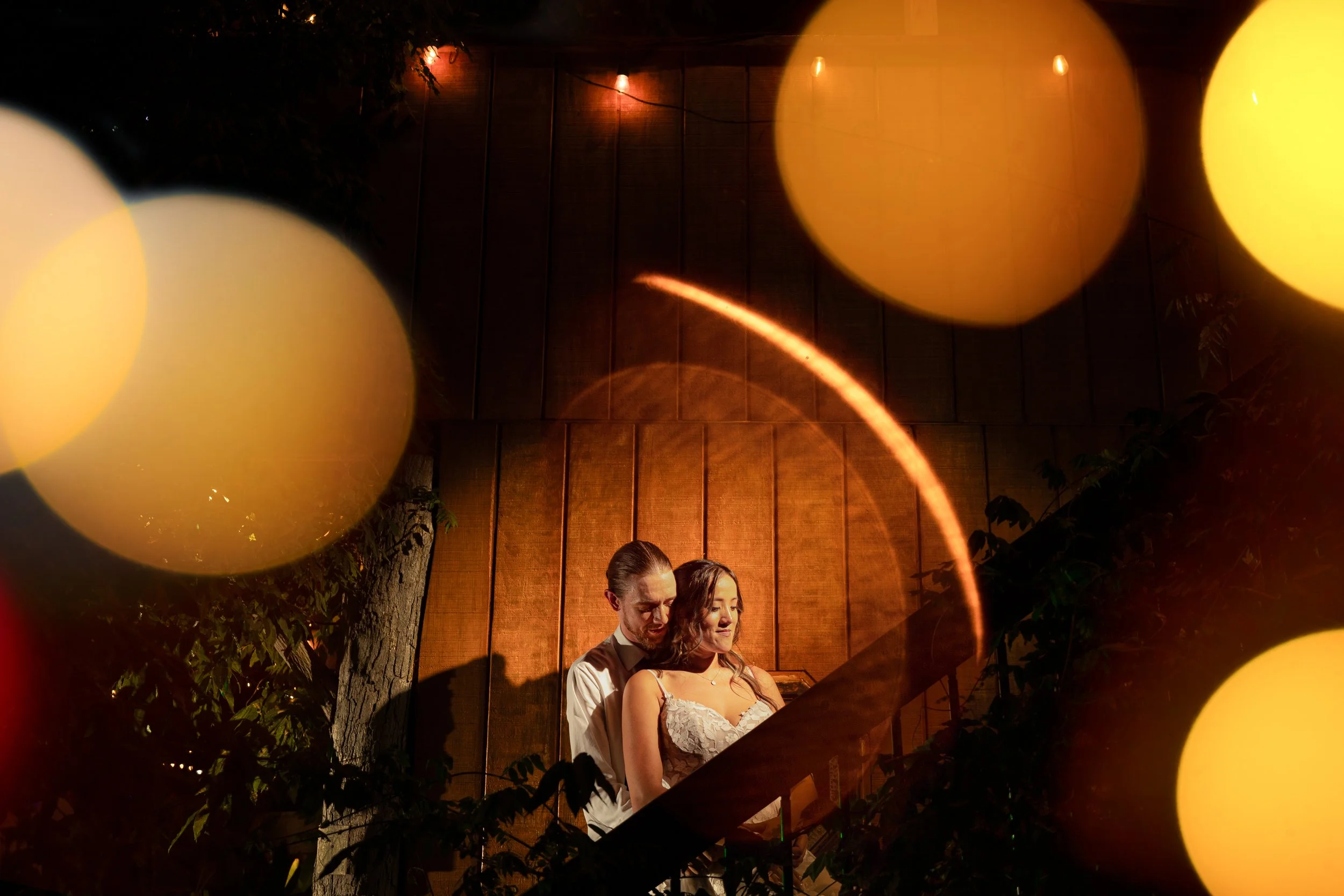 groom holds bride on stairway