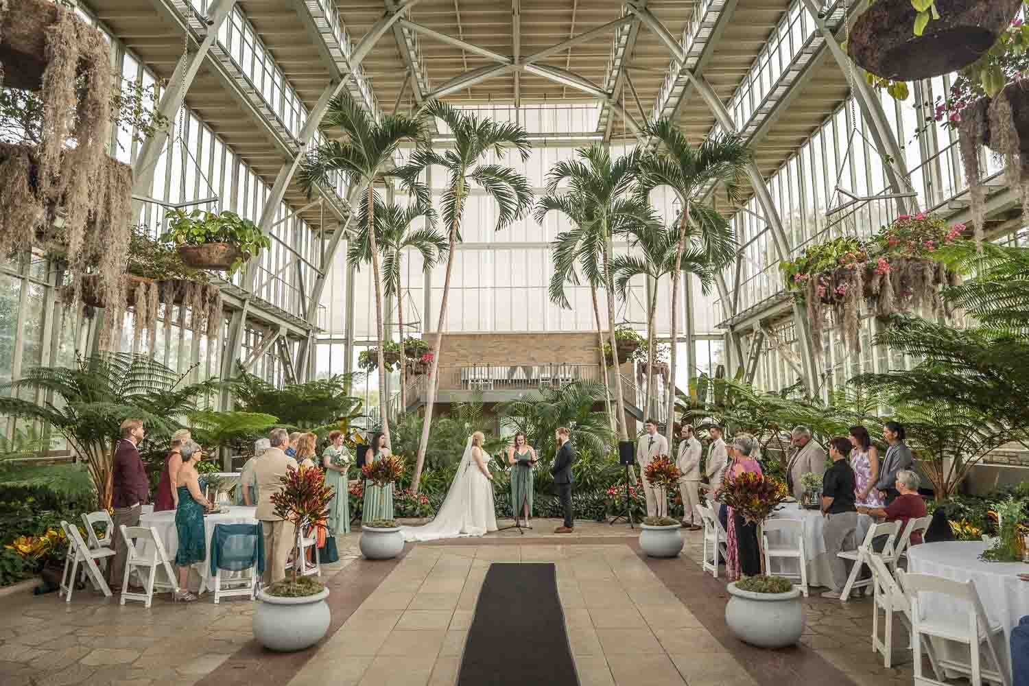 bride and groom saying their vows at the wedding alter in forest park jewel box
