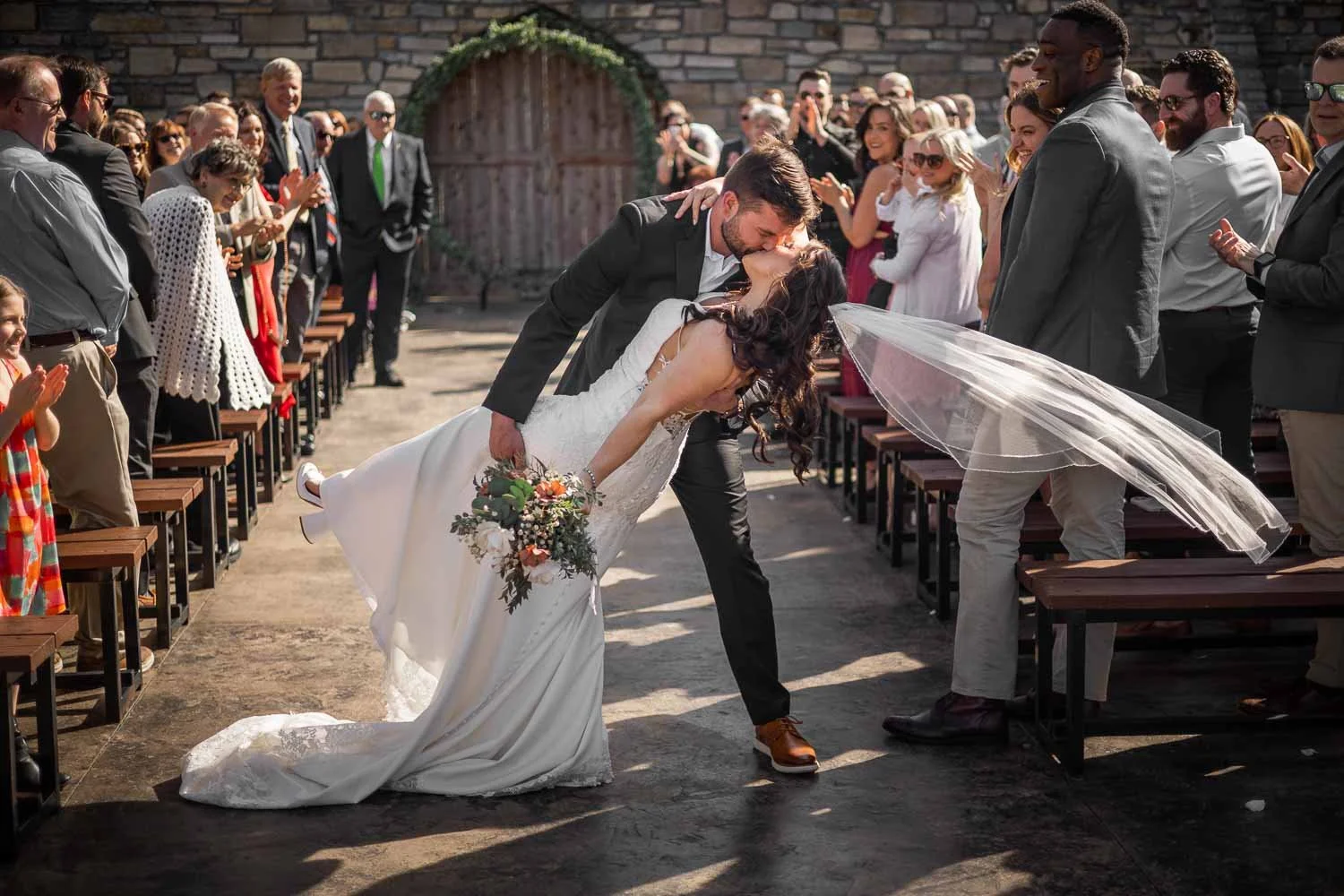 groom dips bride in center aisle and kisses her st louis wedding photography
