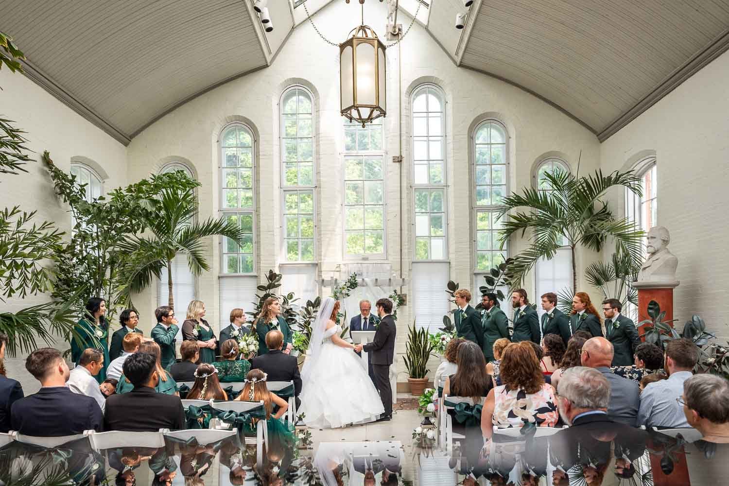 Bride and groom saying vows inside tower grove piper palm house-st louis mo