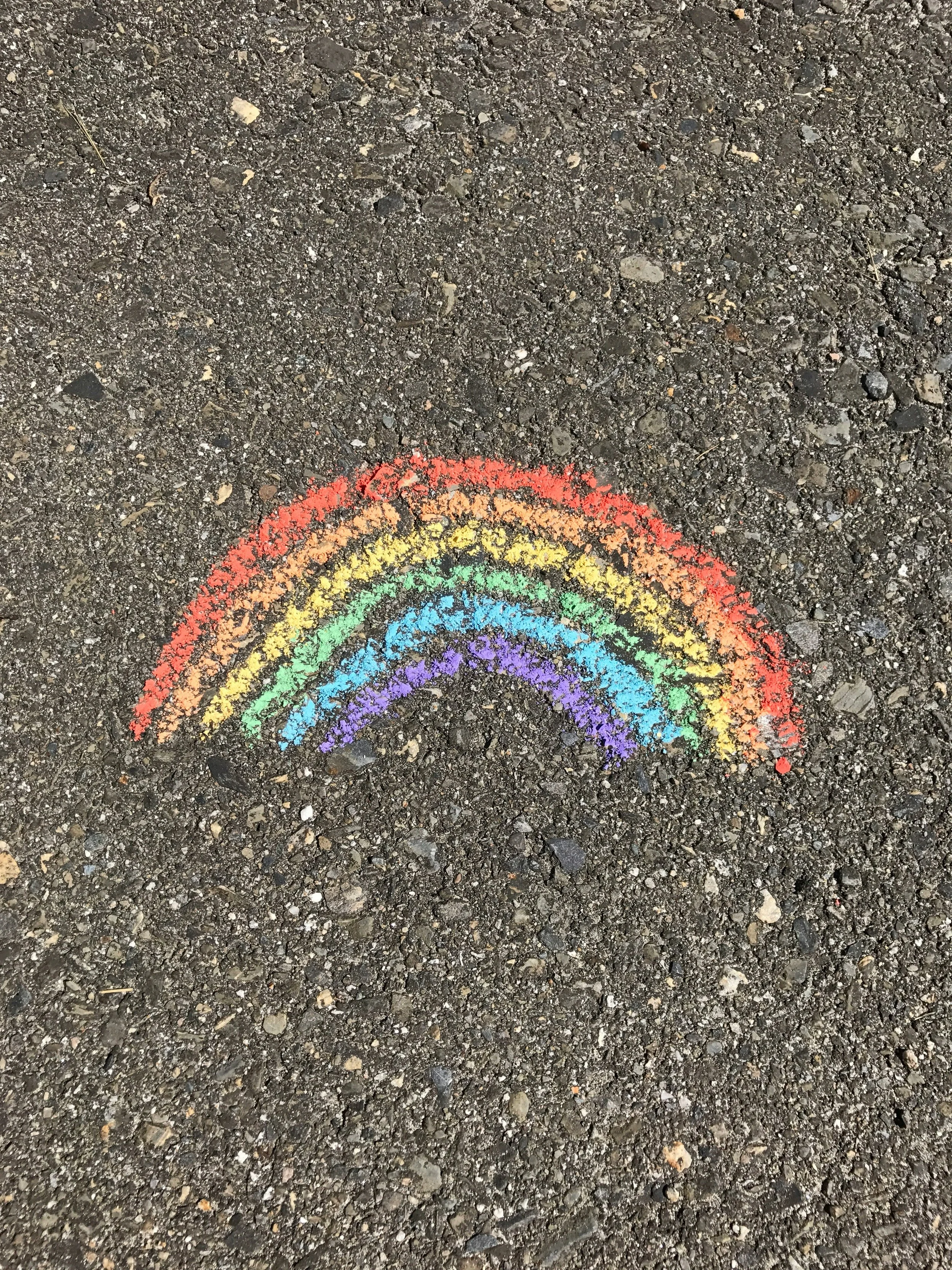 The image of a rainbow on asphalt to accompany a service page about LGBTQ+ therapy
