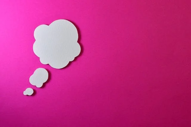 The image of a question bubble on a pink background to accompany a blog post about what does it mean to be transgender. The article is written by an LGBTQ therapist Burnaby running a counselling in Burnaby