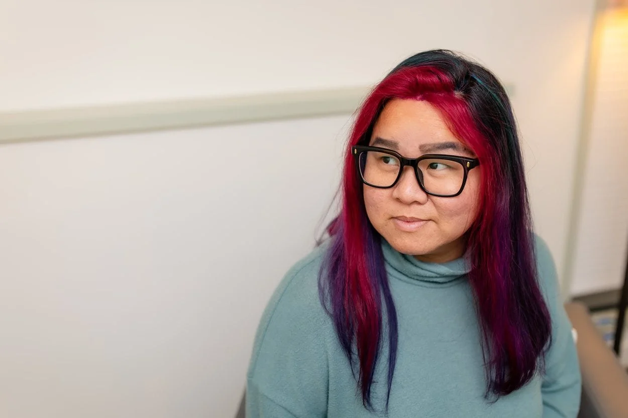 The image of LGBTQ BIPOC transgender counsellor in Burnaby posing to the camera, looking pensive to accompany a blog post about whether am I trans enough. The article is written by an LGBTQ therapist Burnaby running a counselling in Burnaby