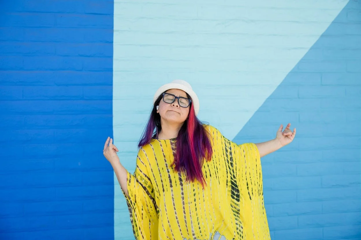 The image of LGBTQ BIPOC transgender counsellor in Burnaby dancing to a beat, looking pensive to accompany a blog post about whether am I trans enough. The article is written by an LGBTQ therapist Burnaby running a counselling in Burnaby