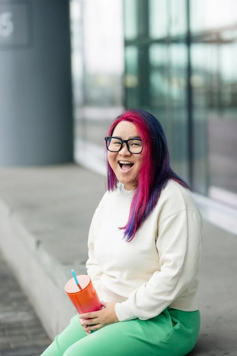 The image of LGBTQ BIPOC youth therapist Burnaby posing to the camera, looking friendly to accompany a blog post about neuroqueer double masking burnout