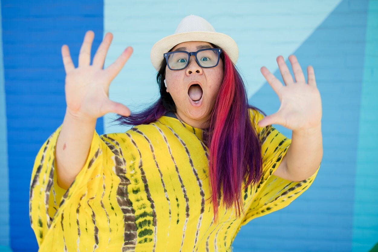 The image of LGBTQ BIPOC youth therapist Burnaby posing to the camera, looking animated to accompany a blog post about neuroqueer double masking burnout