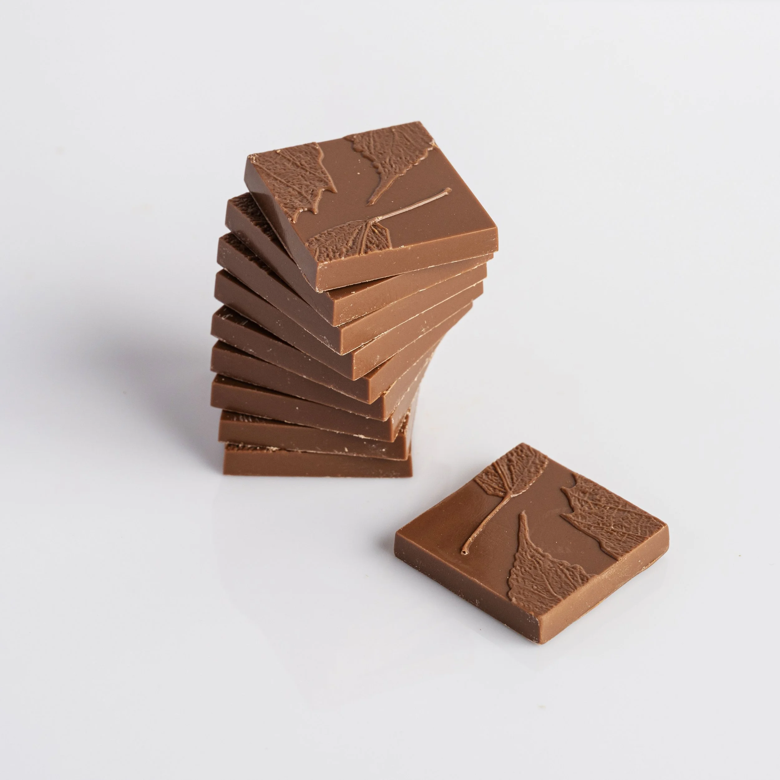 Premium chocolate tasting squares in Belgian milk chocolate containing 35% cocoa content.