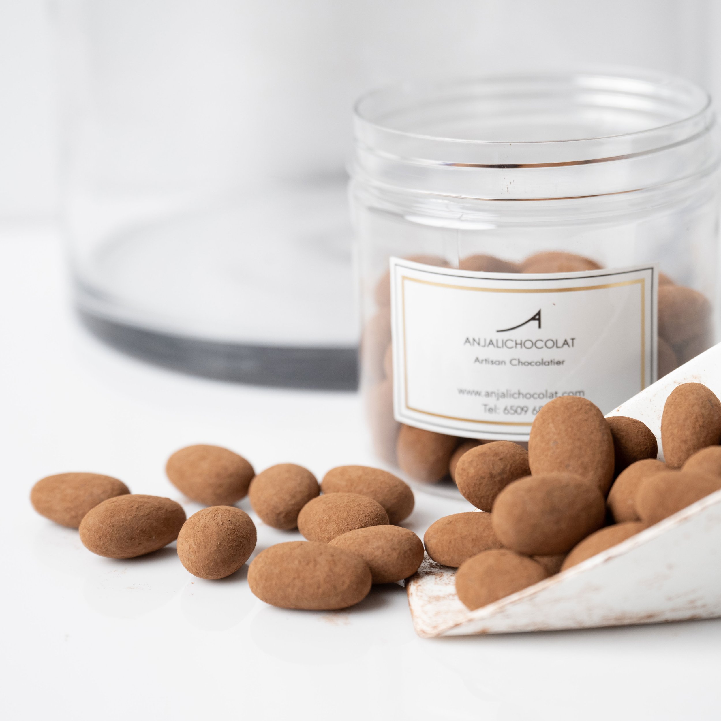 Dark chocolate almond dragées in 250g jar, cocoa dusted