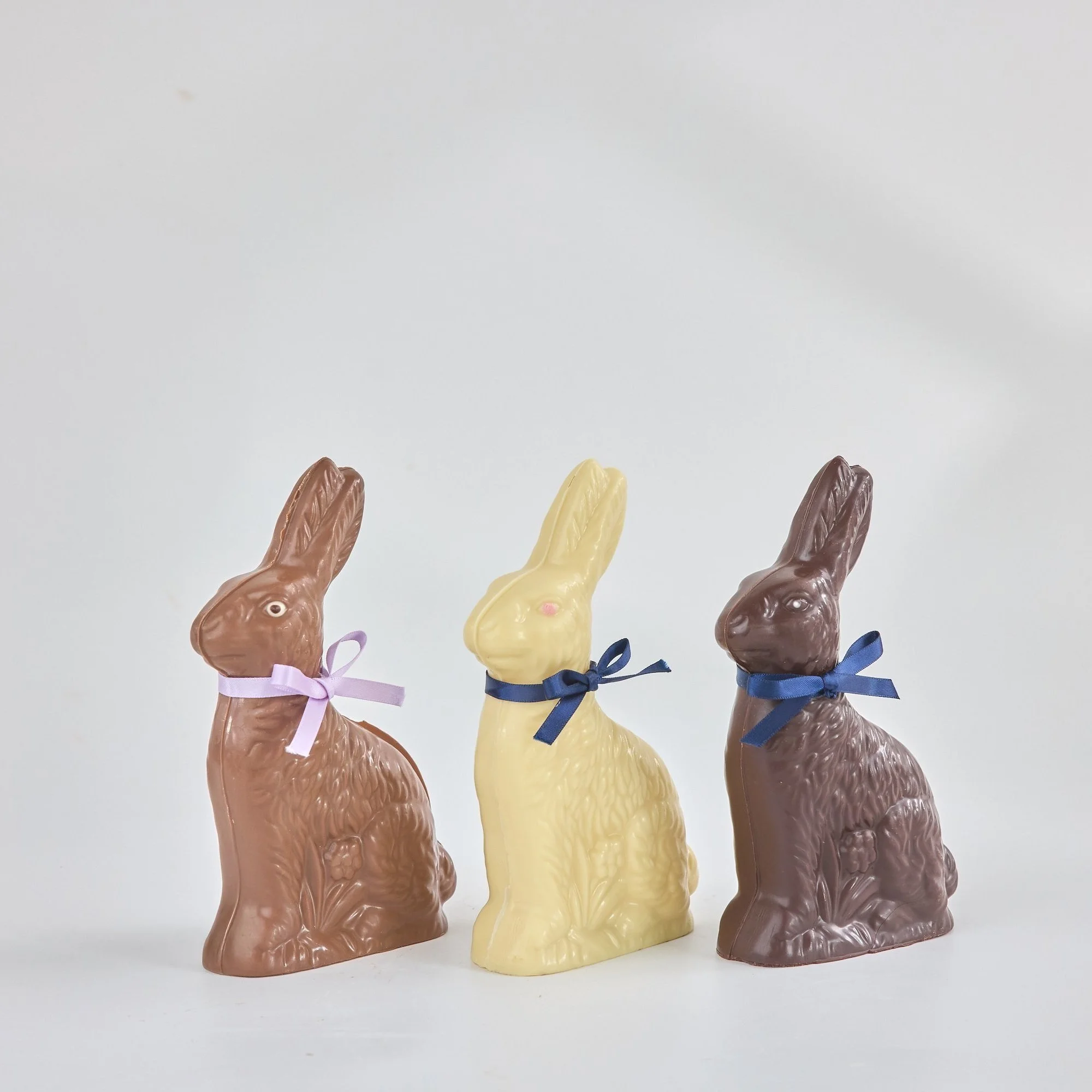 Handcrafted chocolate bunnies for Easter! 18cm tall, made using the finest Belgian couverture in white, milk, and dark chocolate. Perfect gift for Easter.