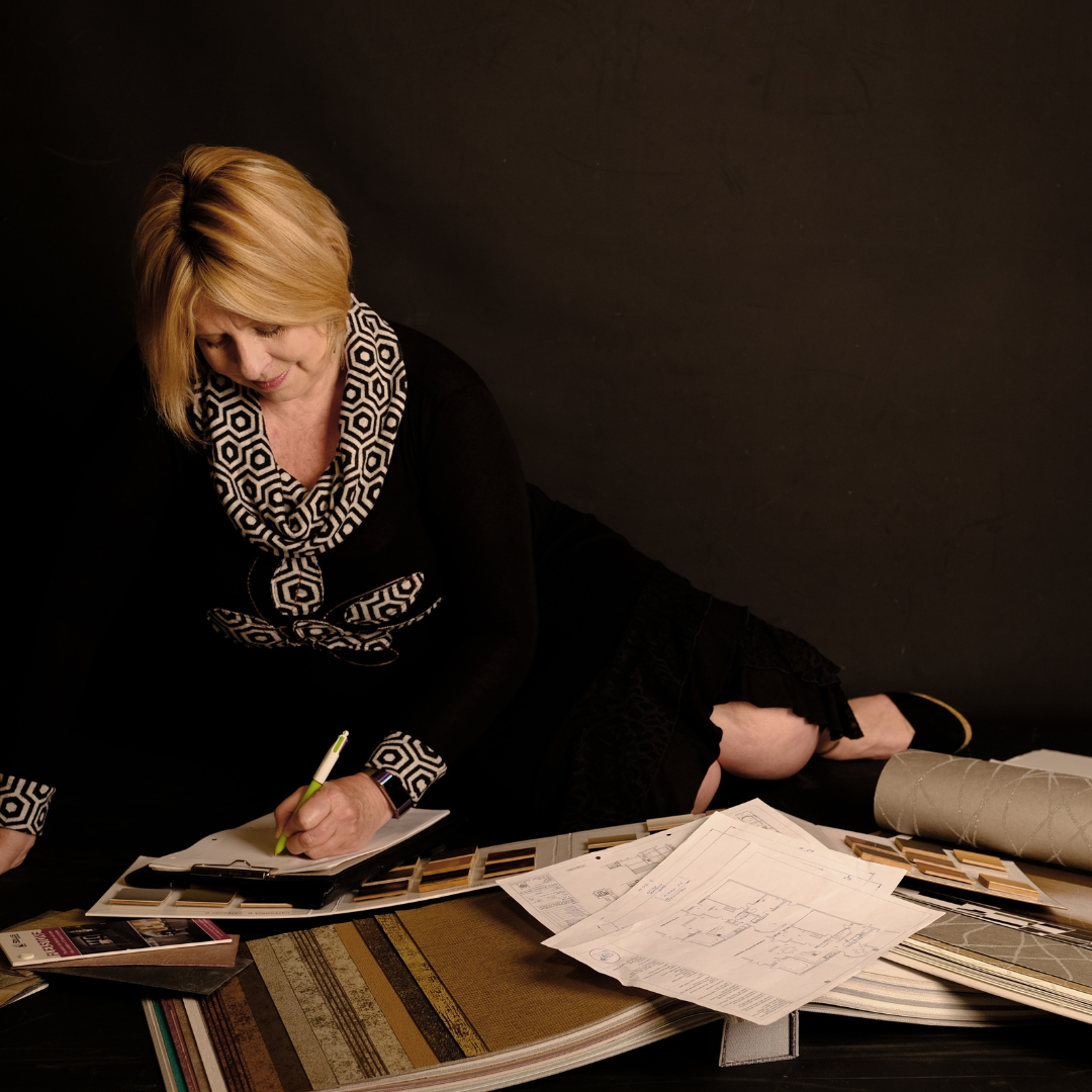 Interior designer Chantal Thomas reviewing plans and material samples for a Design Direction Consultation