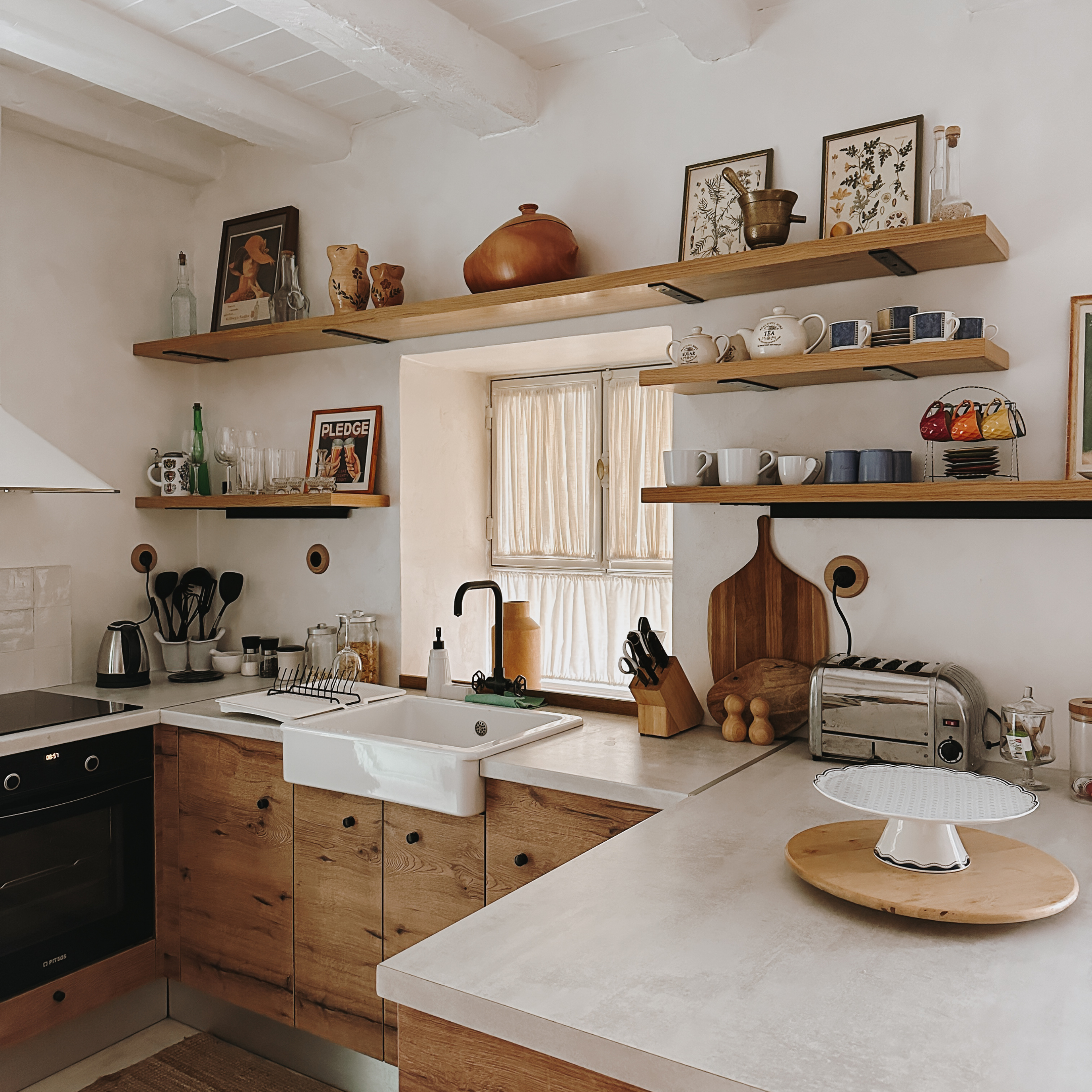 Warm timber kitchen with open shelving, artwork and everyday objects