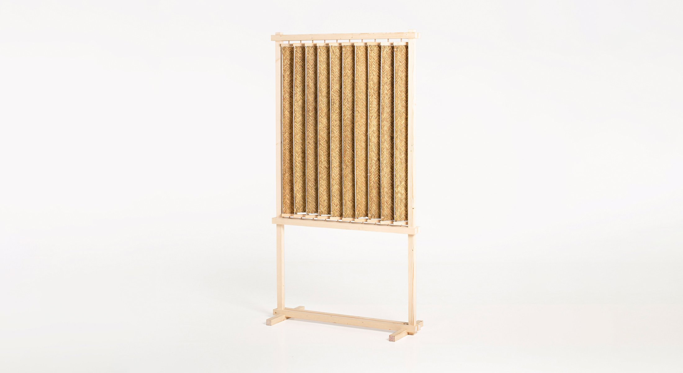 Full studio view of the Nür room divider on a clean white background showcasing its minimalist wood structure and silhouette.