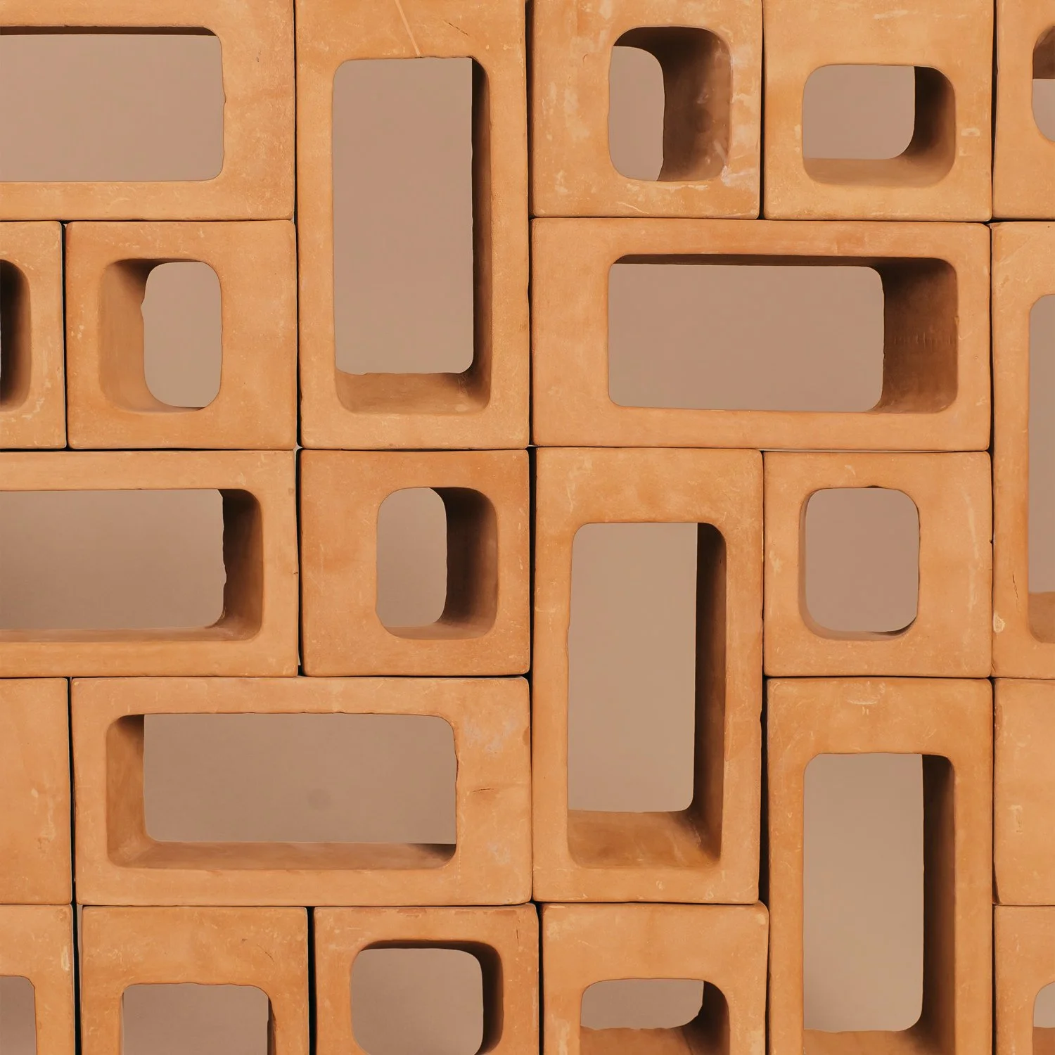 Macro view of a Ronda lattice wall showcasing the precise geometry and the warm texture of hand finished terracotta.