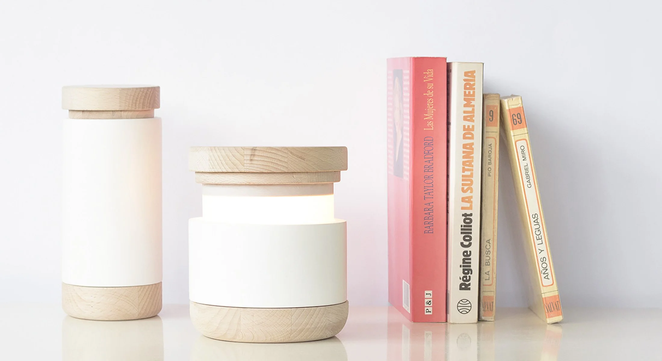 La luminaria Abre en posición abierta, mostrando cómo la luz se libera del recipiente cerámico mediante su mecanismo de deslizamiento.