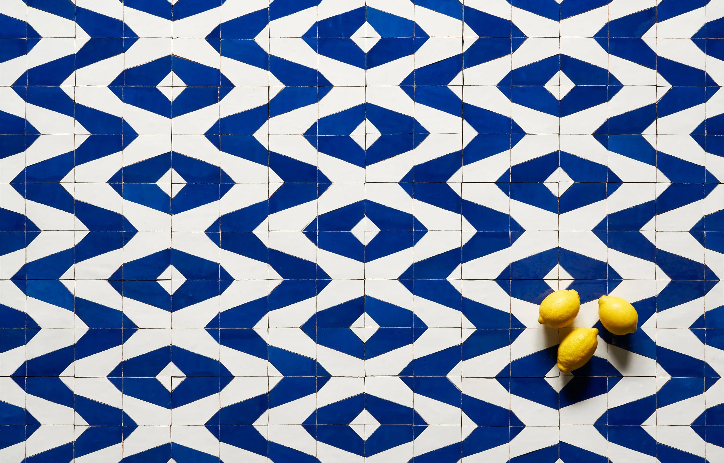 Traditional zellige production process showcasing the manual assembly of intricate mosaic patterns.