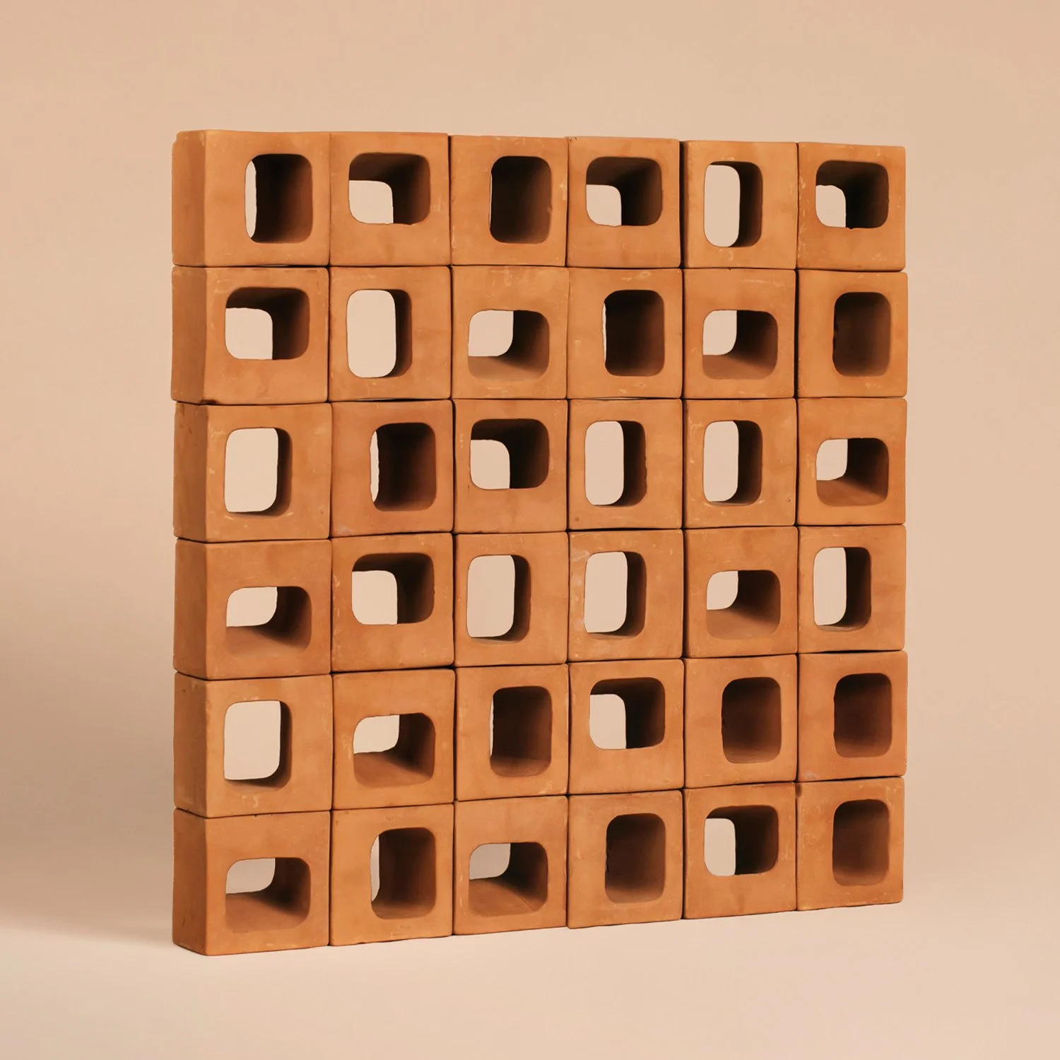 A rhythmic pattern created with Ronda 12 terracotta modules showing the play of light and shadow through oblique openings.