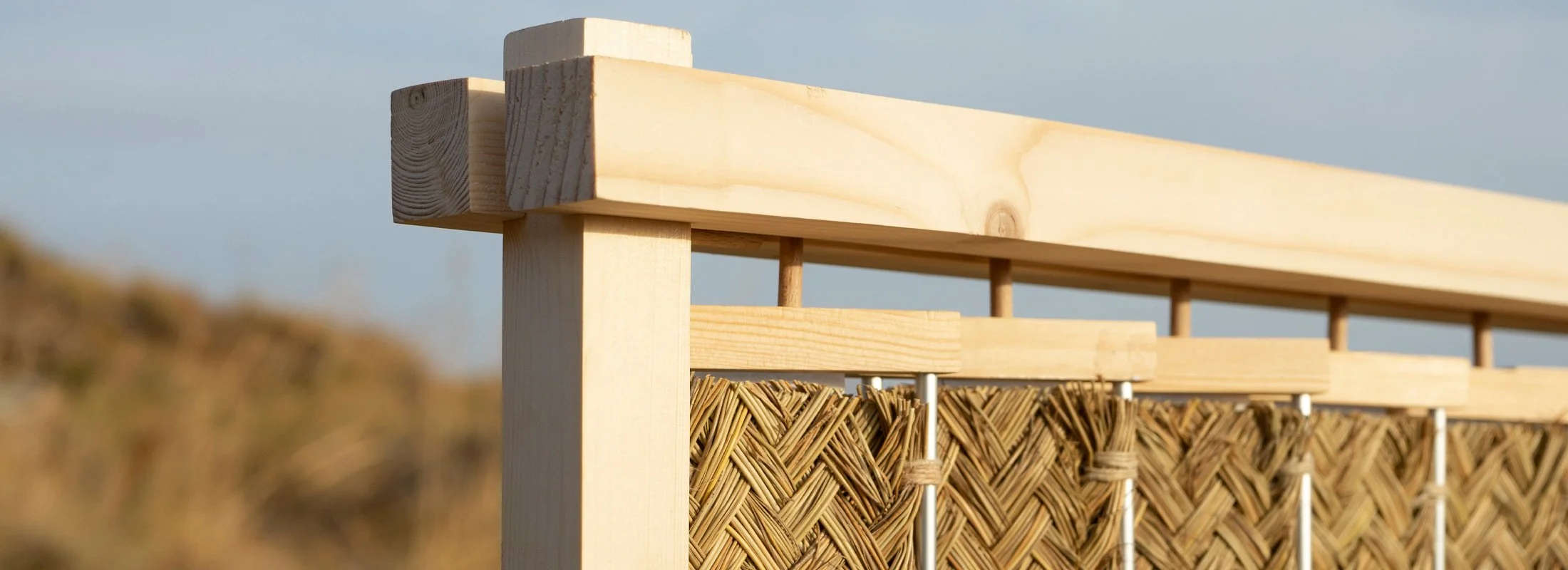 The Nür sculptural screen designed by Carlos Jiménez filtering soft Mediterranean light through natural esparto grass fibers.