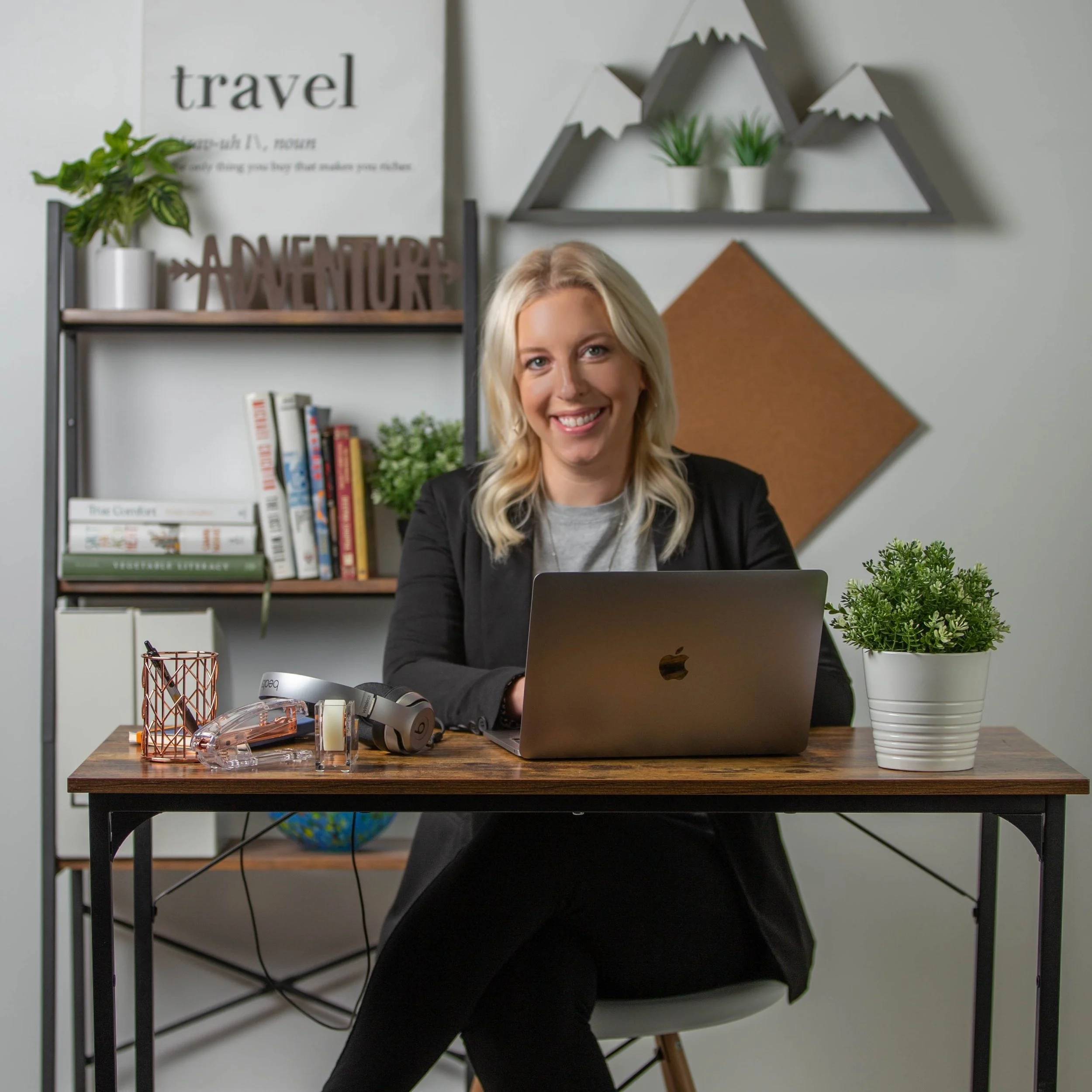 Woman sitting at desk with Apple MacBook Pro laptop