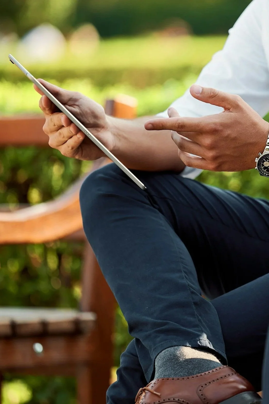Man showing someone something on a tablet or iPad.