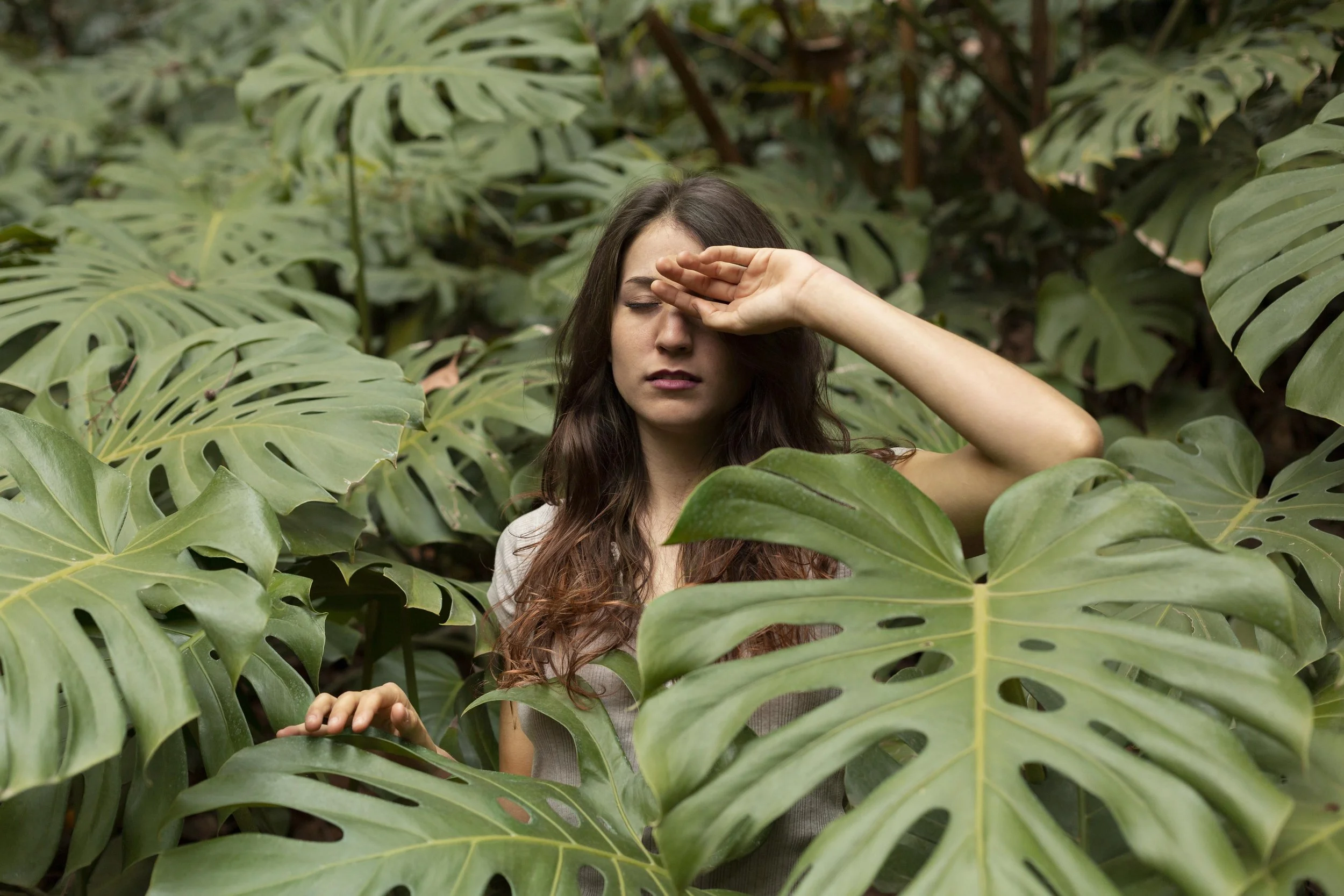 woman surrounded by leaves frustrated with repeating relationship patterns