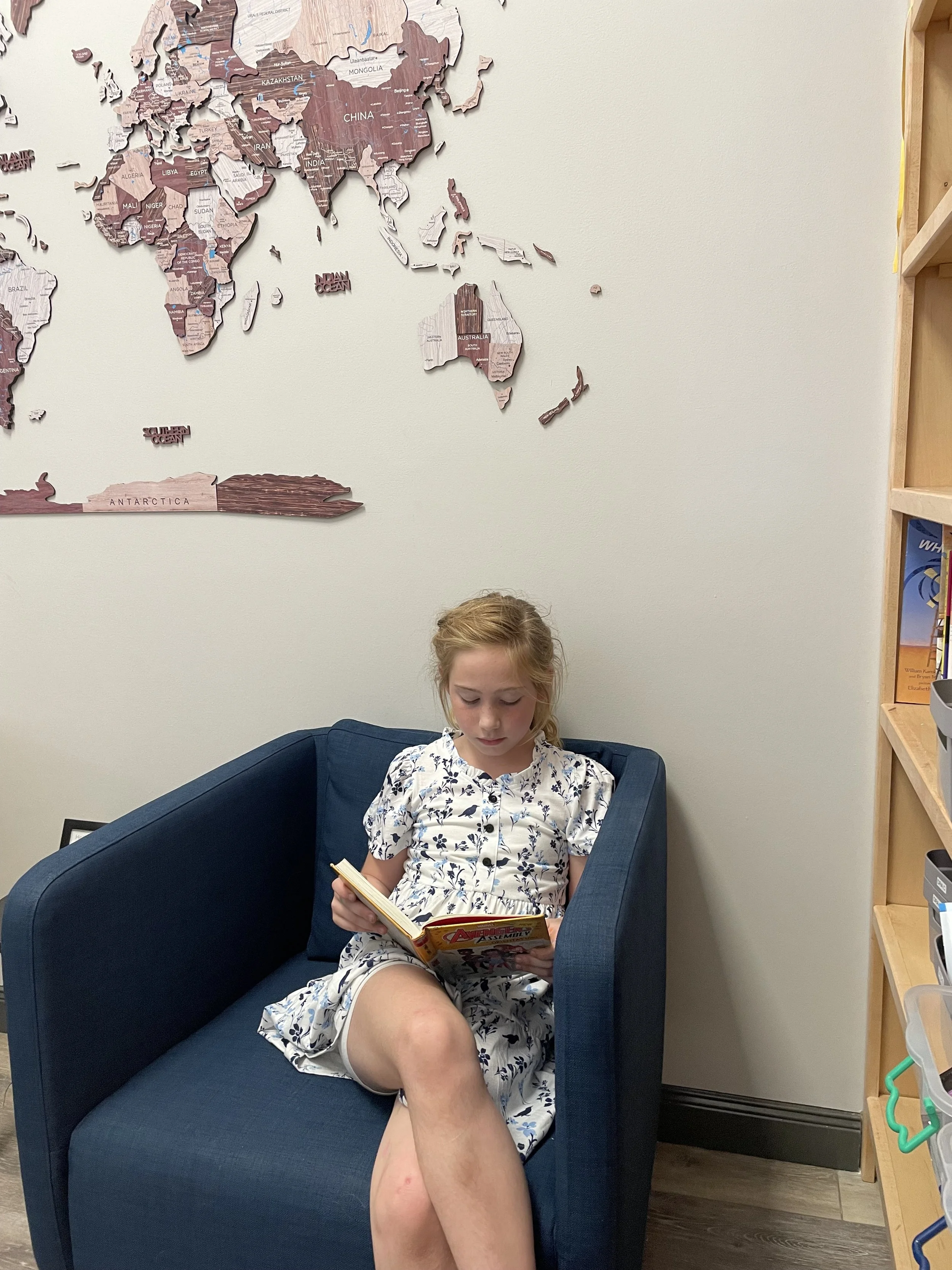 A student reading an Accelerated Reader book in the Reading Room during a Tutoring session.