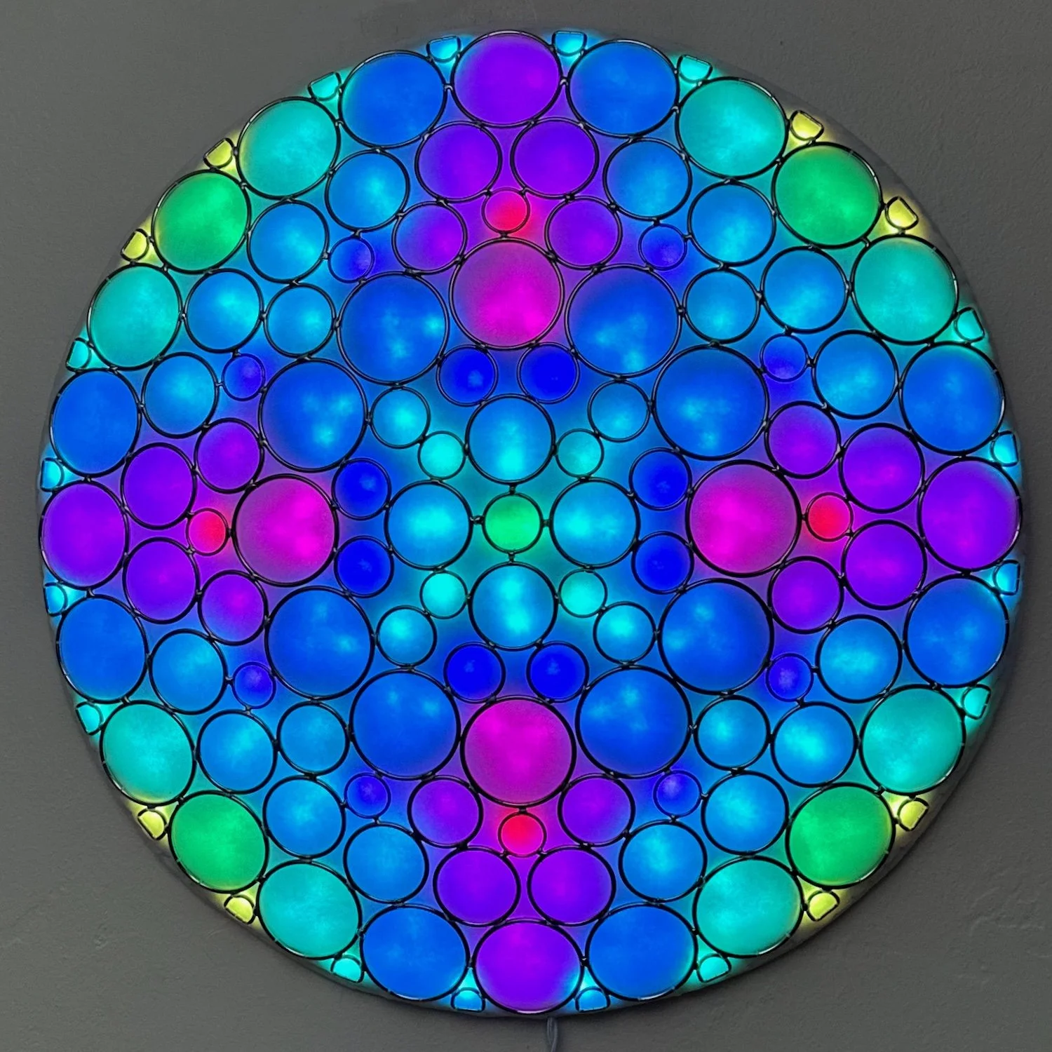Janet Hansen, "Enlightened Rings 22," soldered metal rings, RGB LEDs, white diffusing layer, 30 x 22 x 1 inches.