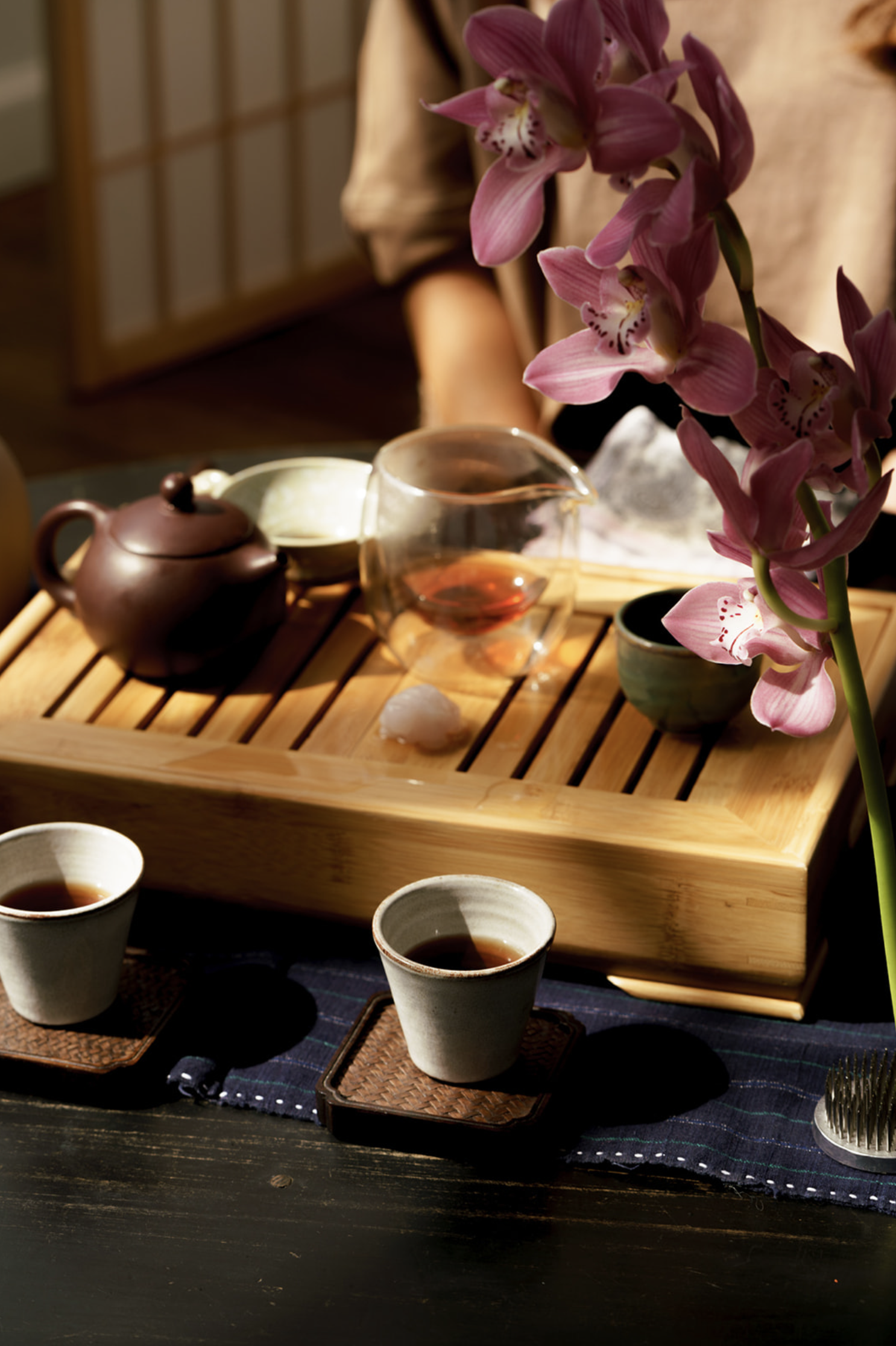 a holistic business coach sits in front of a glass teapot