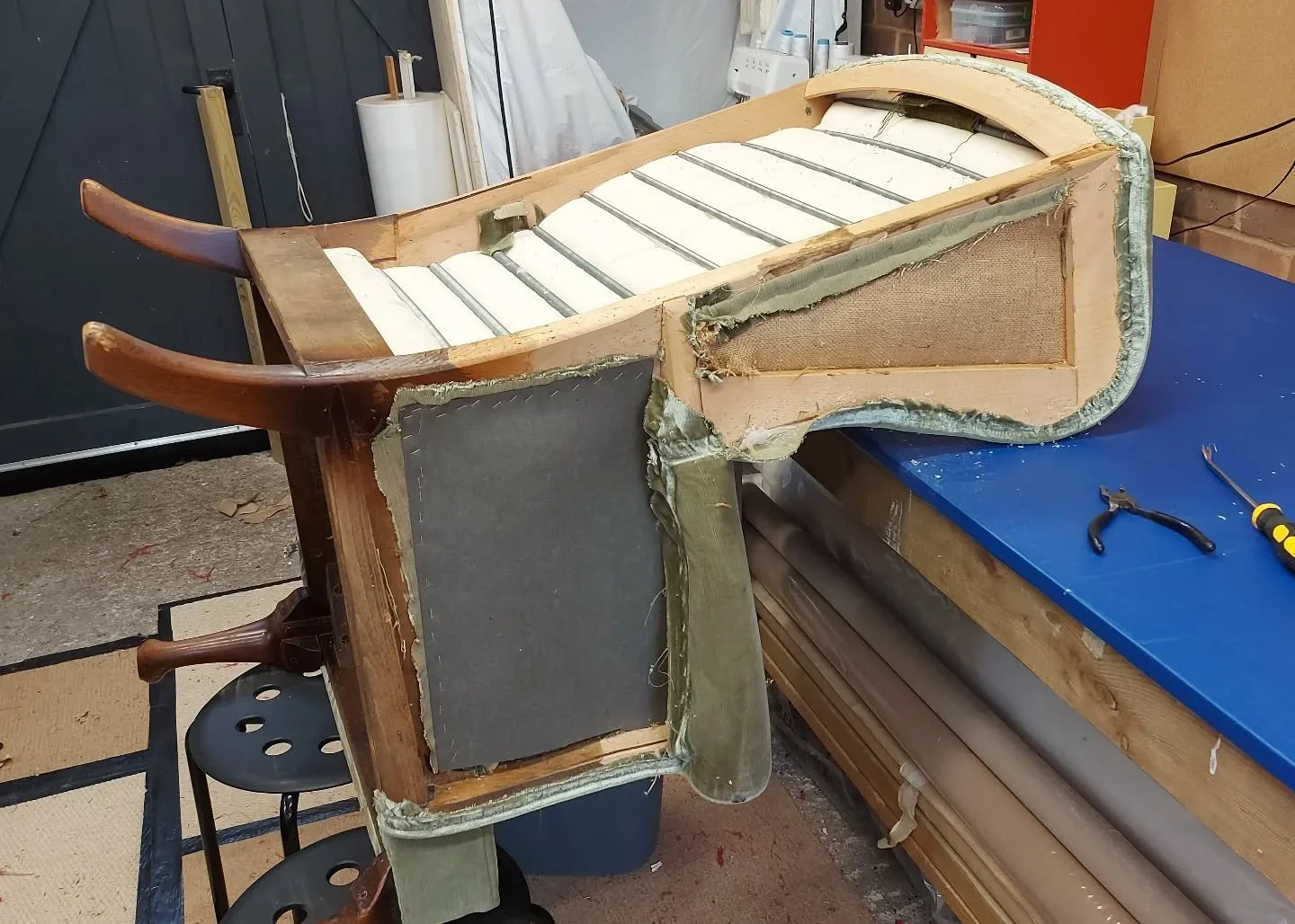 Parker Knoll wing back chair.
Today I am starting to strip away the top cover of fabric, carefully preserving all the layers underneath. The cover is really dated and the client wanted something that will fit in with her existing furnishings.
The spr