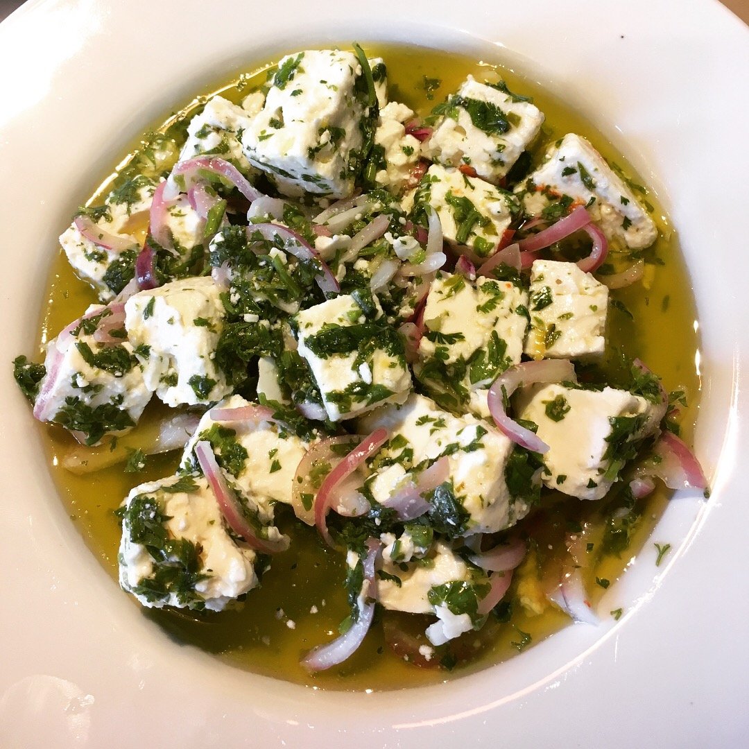 Marinated feta with herbs, red onion and olive oil.