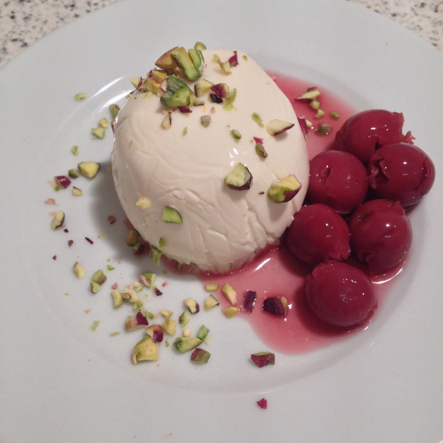 Vanilla panna cotta with chopped pistachios.