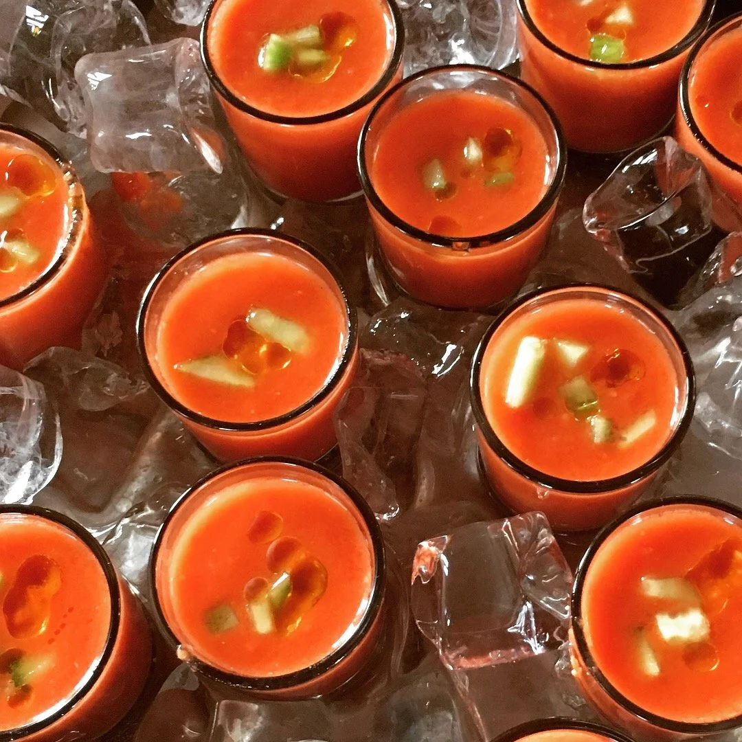 Gazpacho served in shot glasses.
