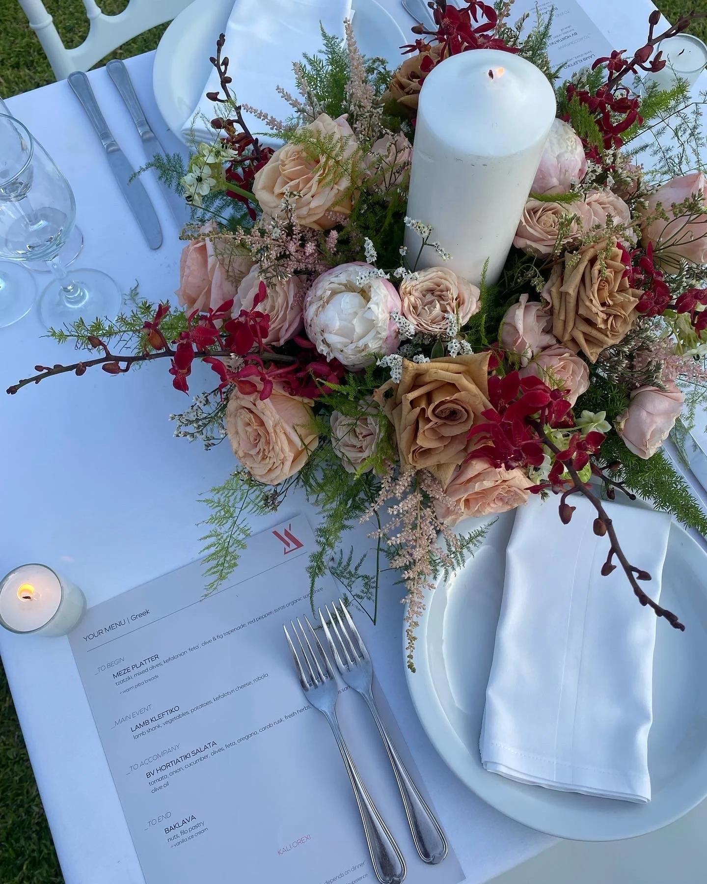 Elegant table setting with floral centrepiece and printed menu.