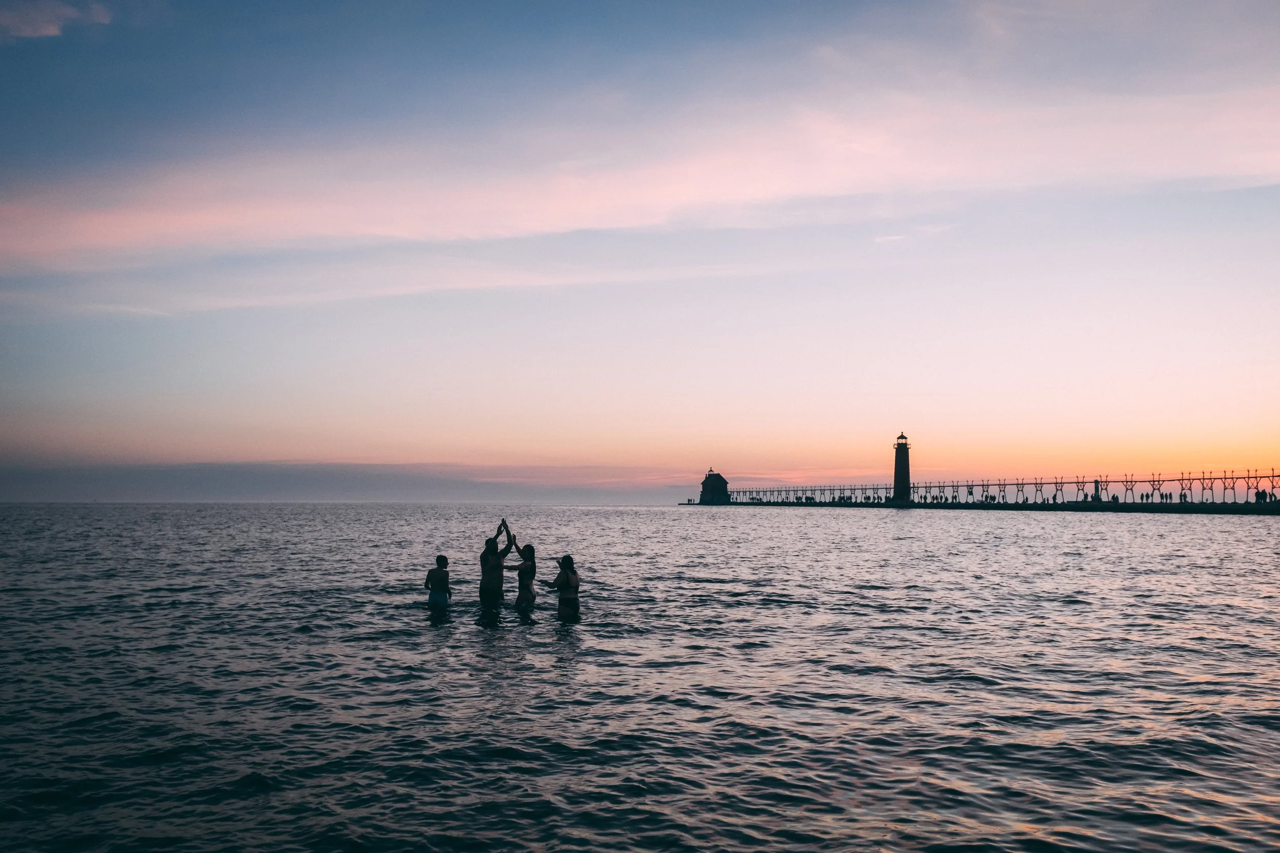 People swimming at sunset in Lake Michigan