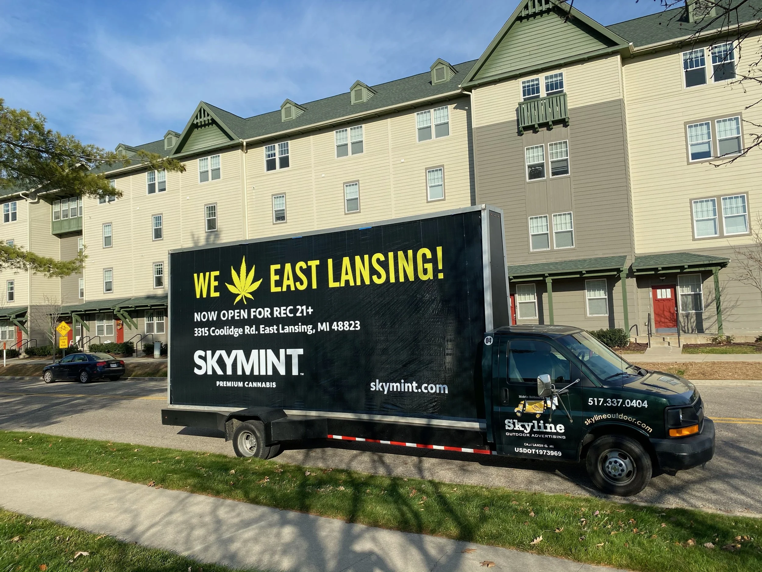 A mobile billboard example with the words "We Love East Lansing" as the headline