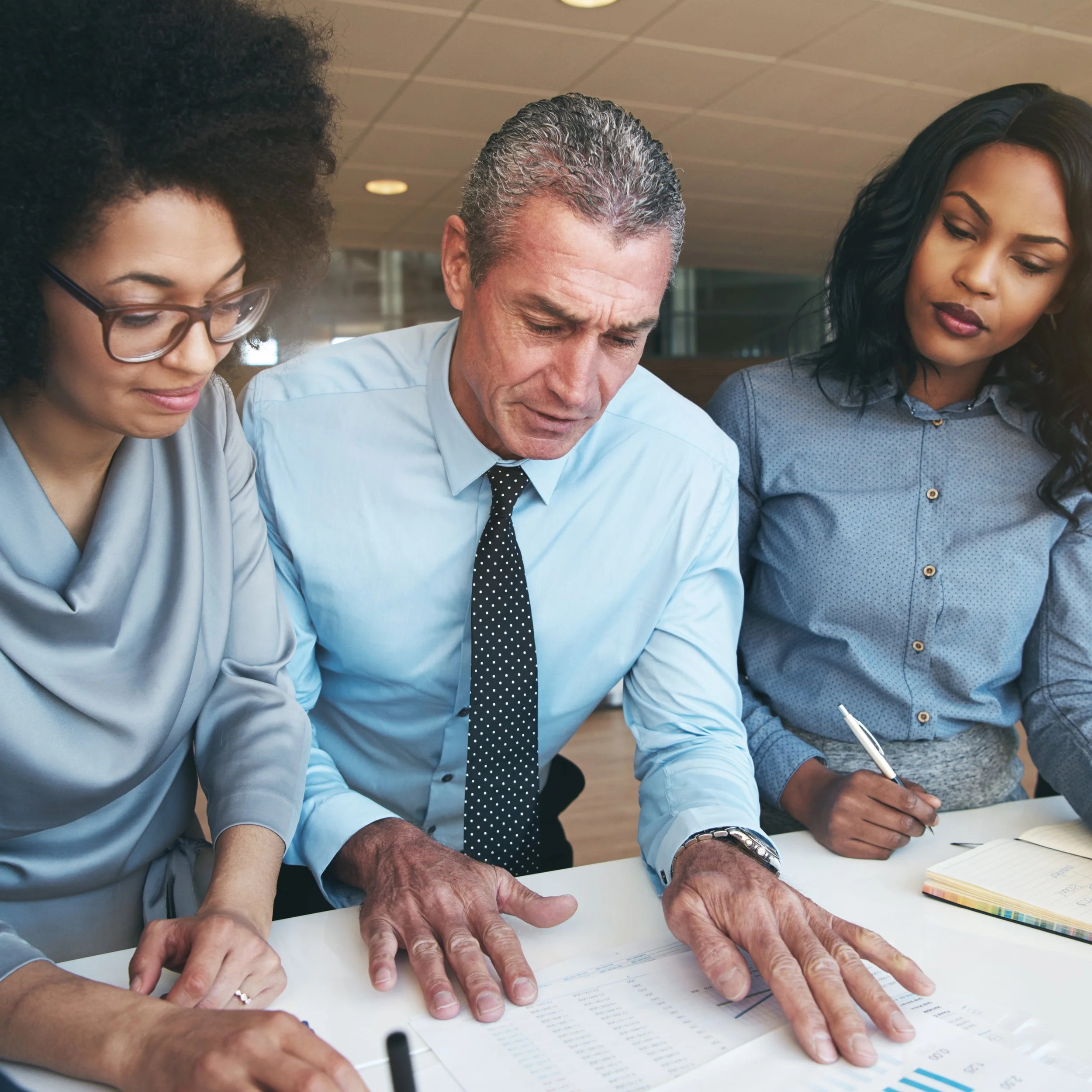 Team reviewing project plans to ensure strategic alignment and consistent execution.