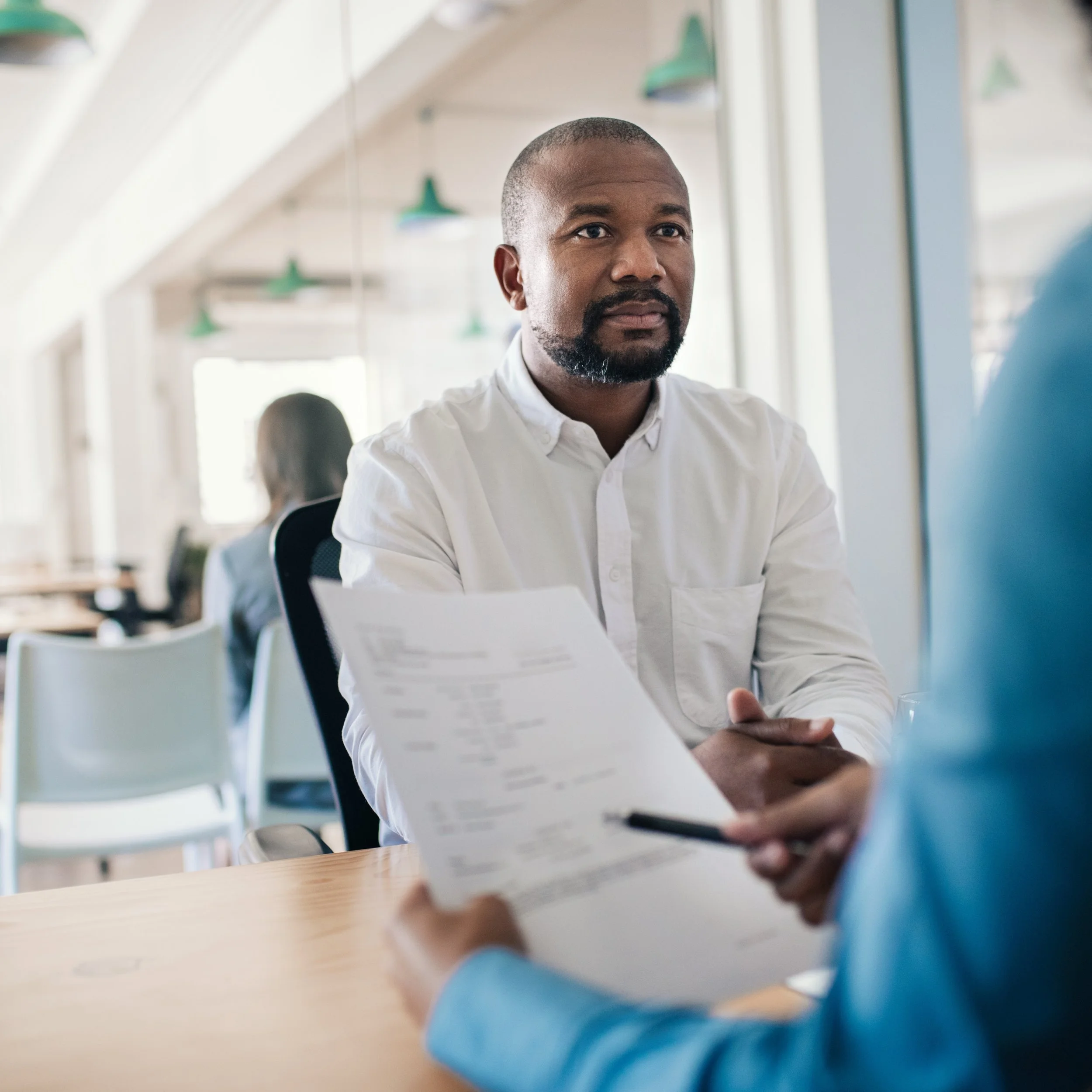 Executive coach listening attentively during a leadership coaching conversation.