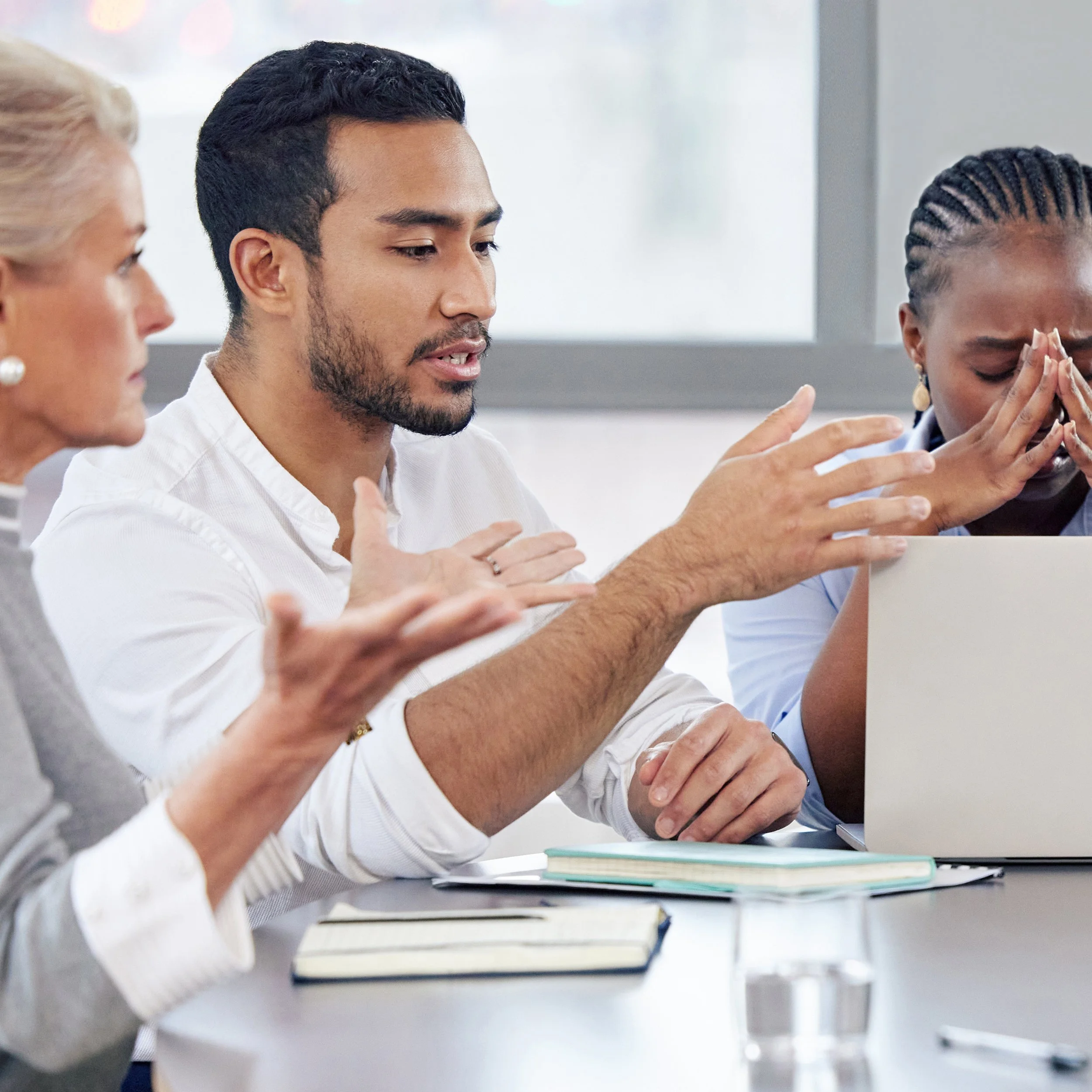 Tense team discussion reflecting communication breakdown and team friction