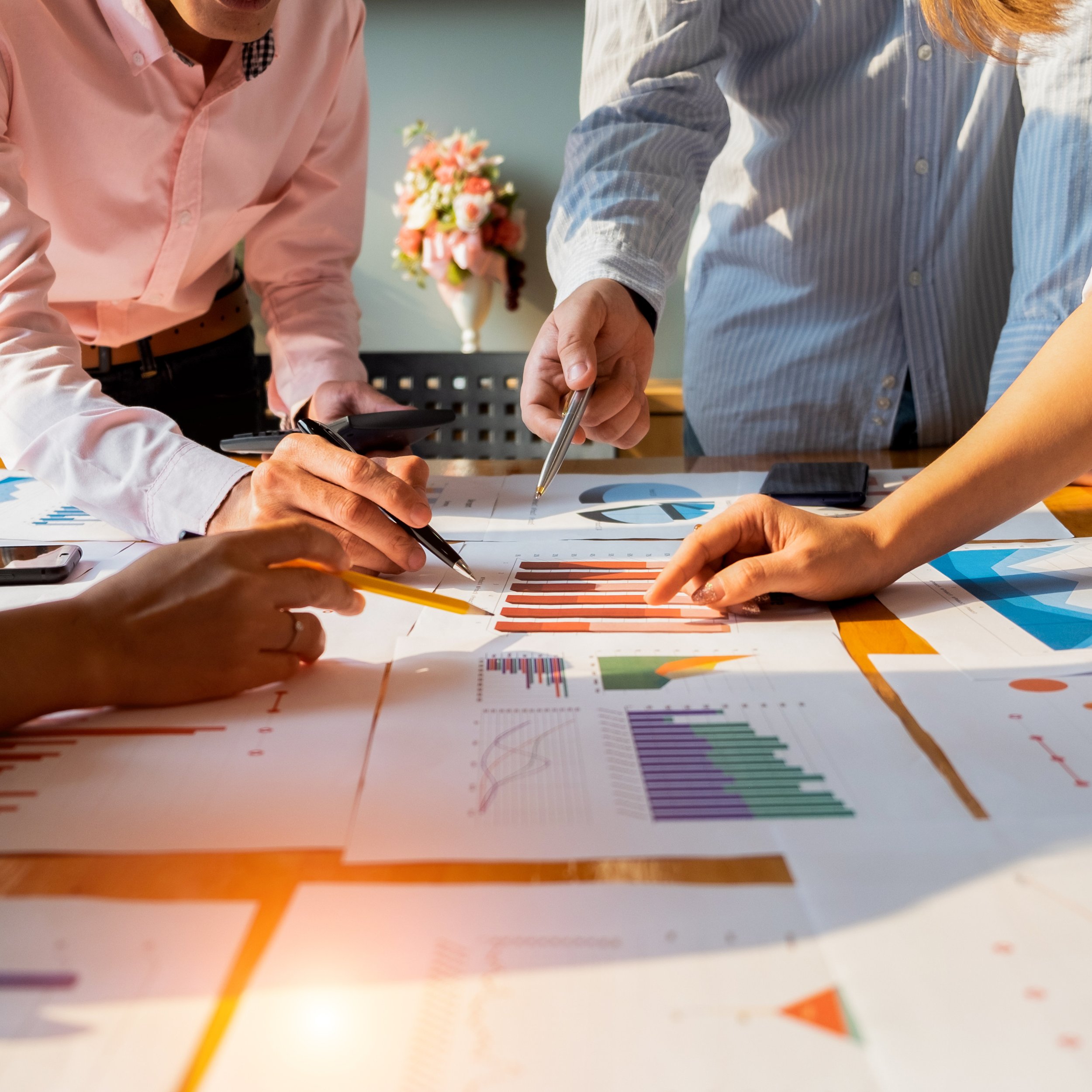 Leadership team reviewing strategic plans and charts to align on priorities and decision standards.