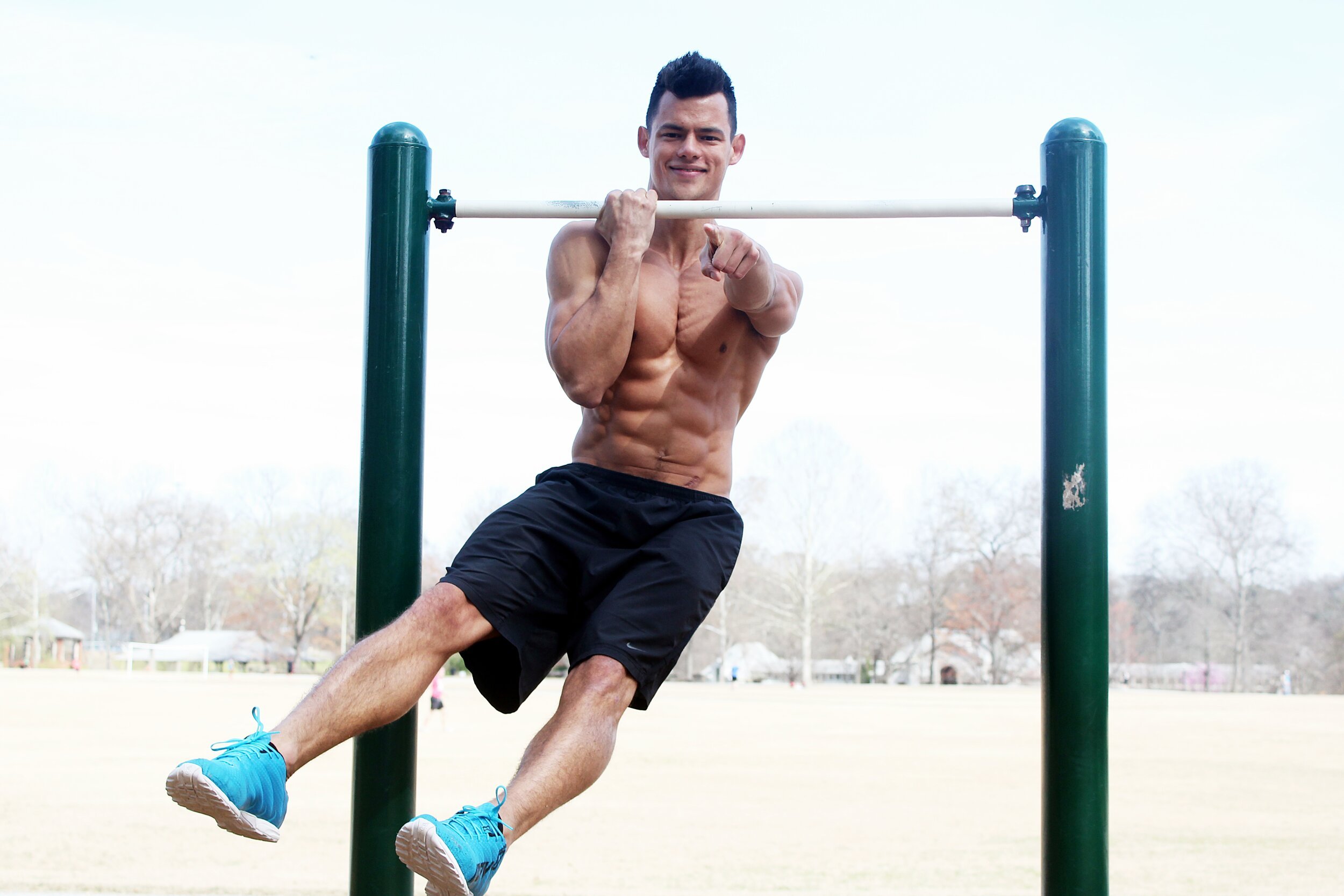 male personal trainer on pull up bar