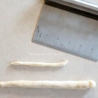 Roll each piece into a rope - one long &amp; one short