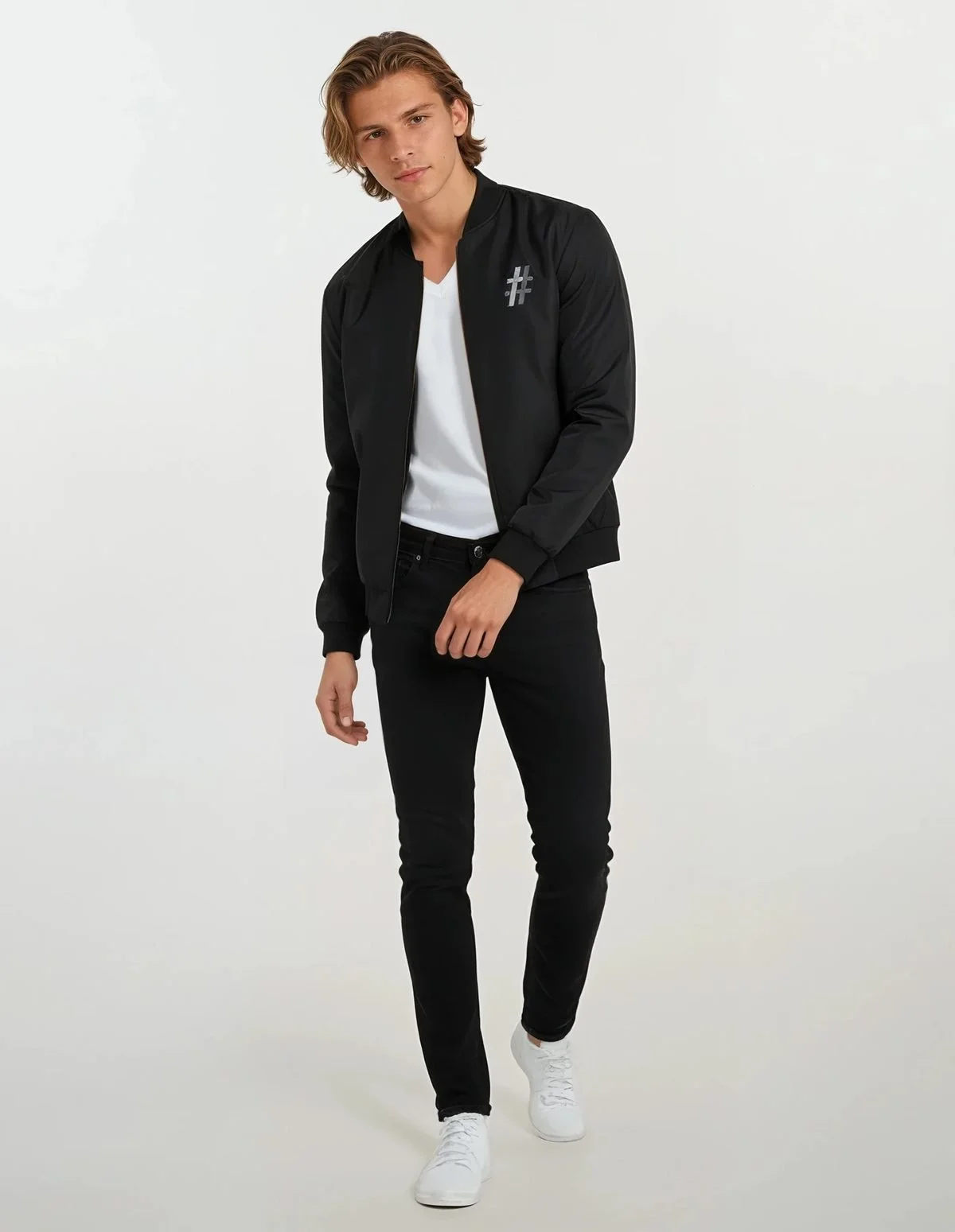 Man in a black bomber with a silver # mark over a white tee